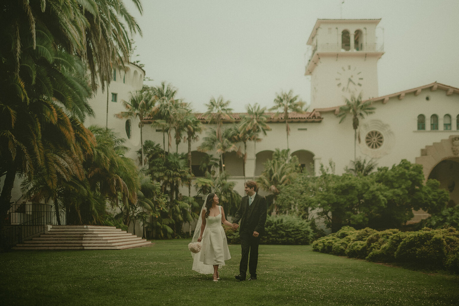 Newlyweds beneath the Santa Barbara County Courthouse tower