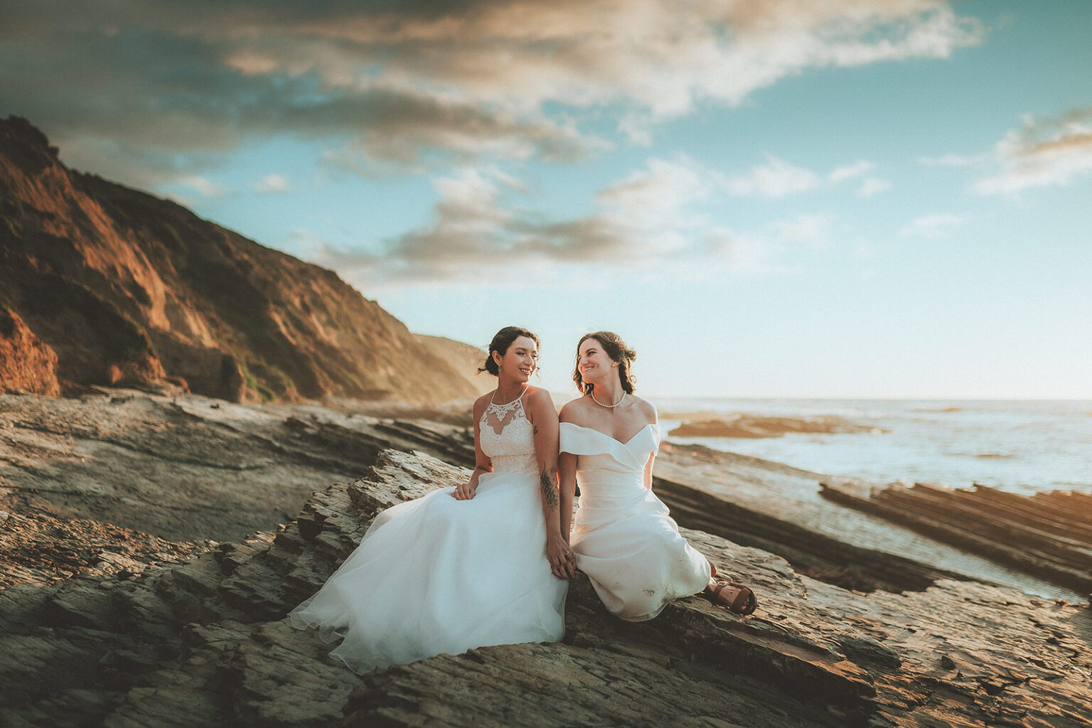 Two newlyweds in a wide Central Coast landscape portrait