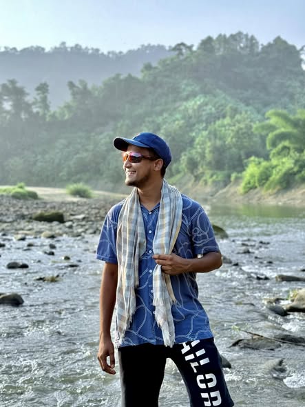 Standing in a shallow rocky stream under morning haze, Bandarban.