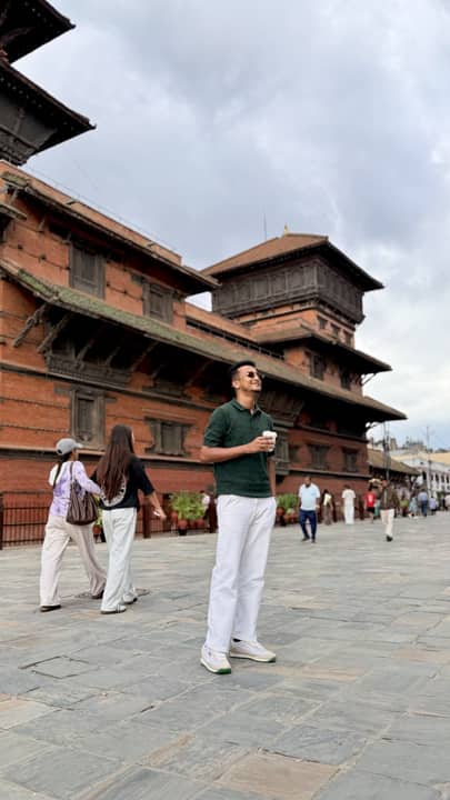 In a brick square below a tiered temple, Nepal.