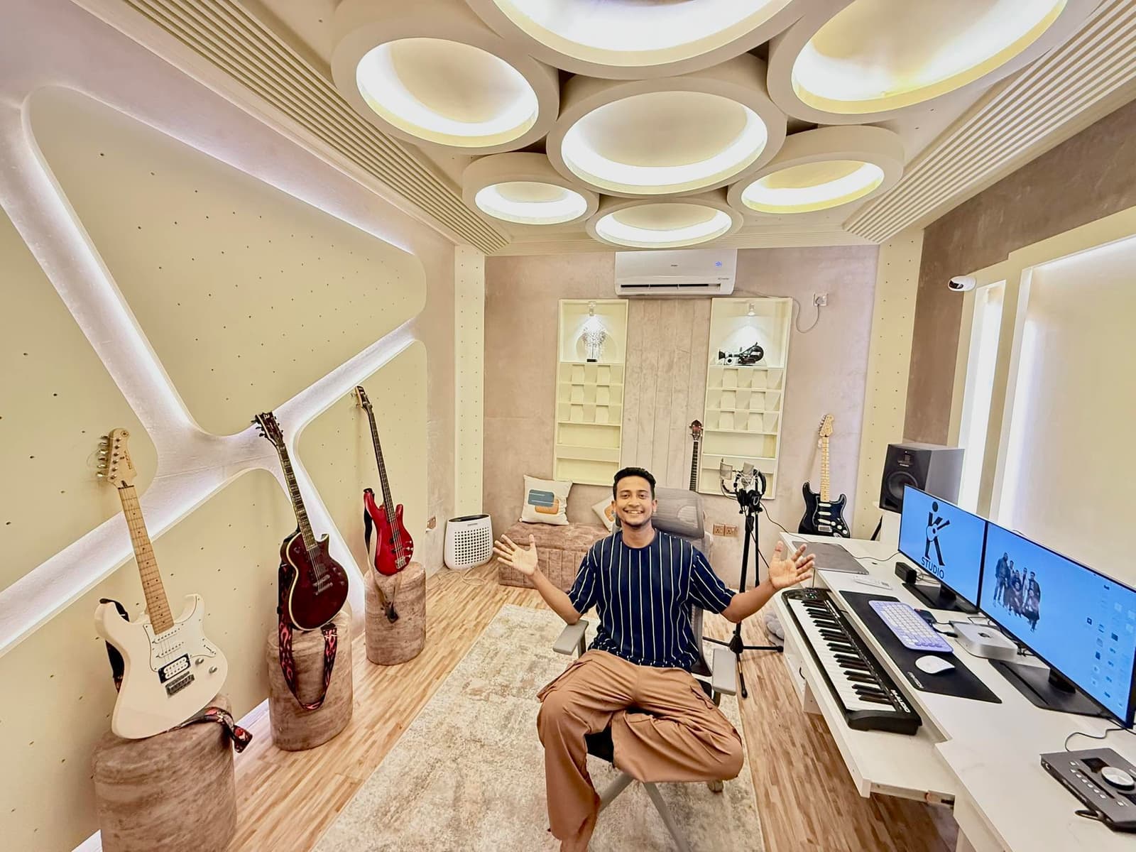 Tasrif Khan recording, headphones on, at a studio microphone.