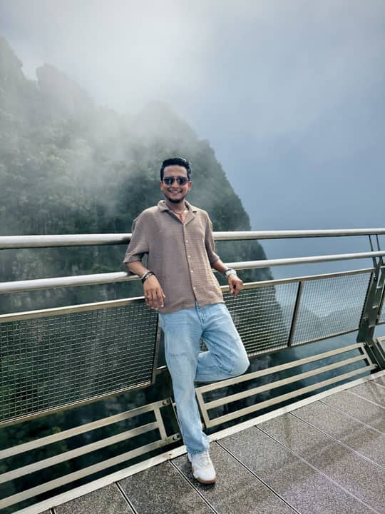 Leaning on a railing in mountain cloud, Malaysia.