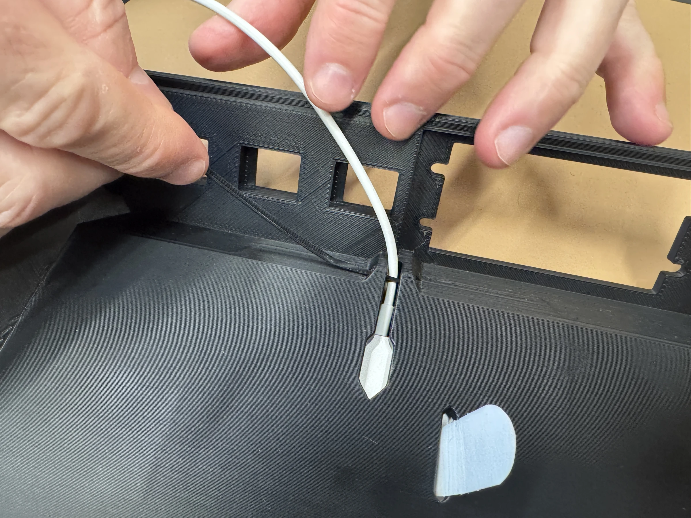 Photograph 12. The cable passing through the opening on the underside of the insert.
