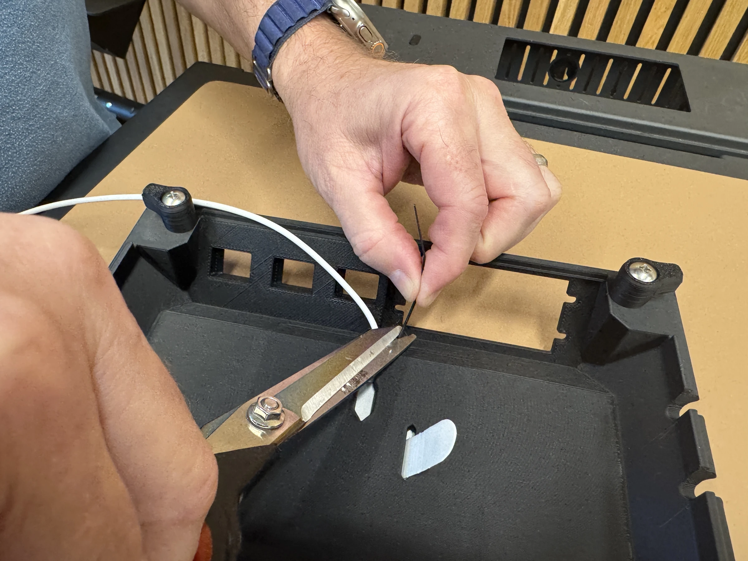 Photograph 15. Trimming the cable tie tail.