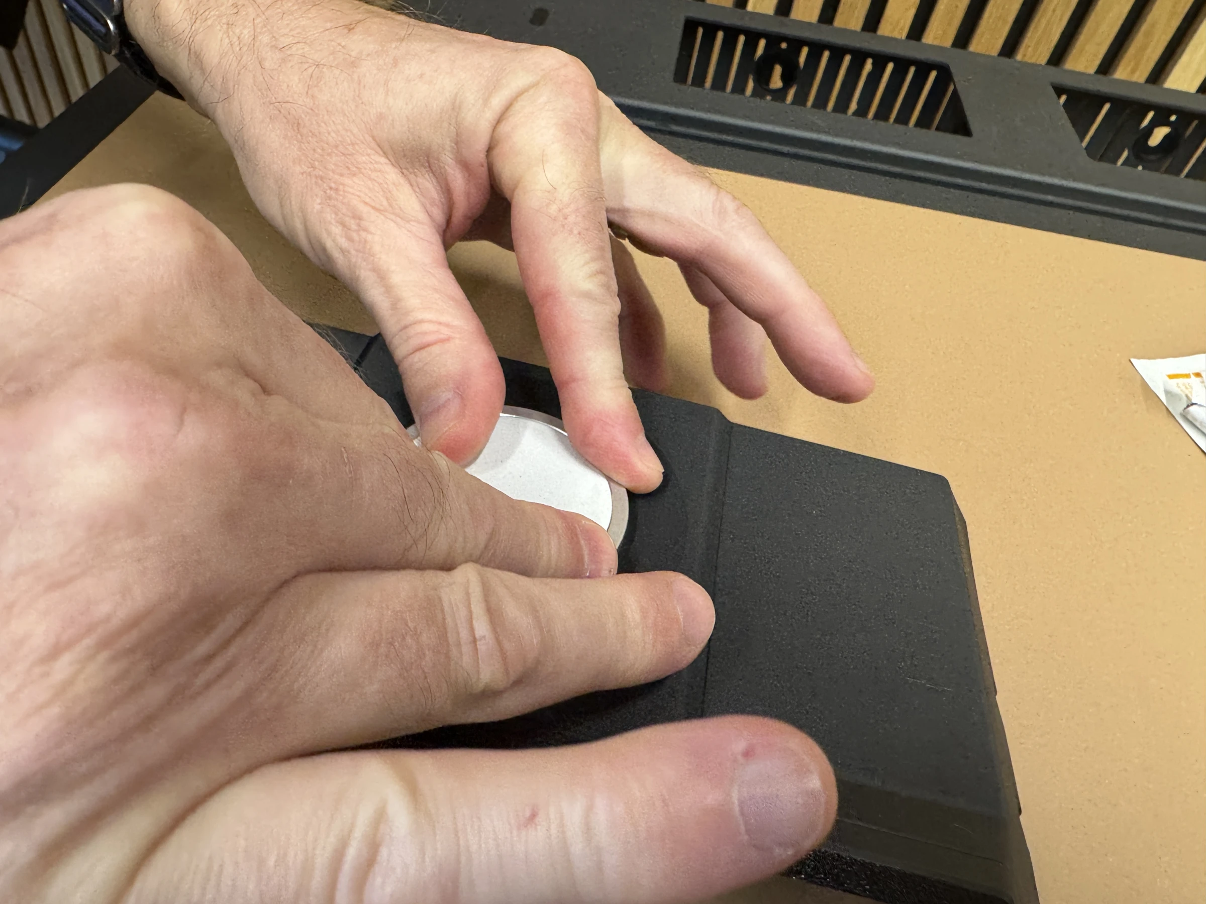 Photograph 10. Pressing the charging puck into the recess.