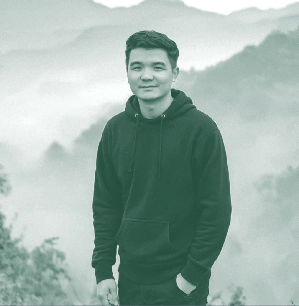 Portrait of the Slixel designer in a black hoodie against misty mountains.