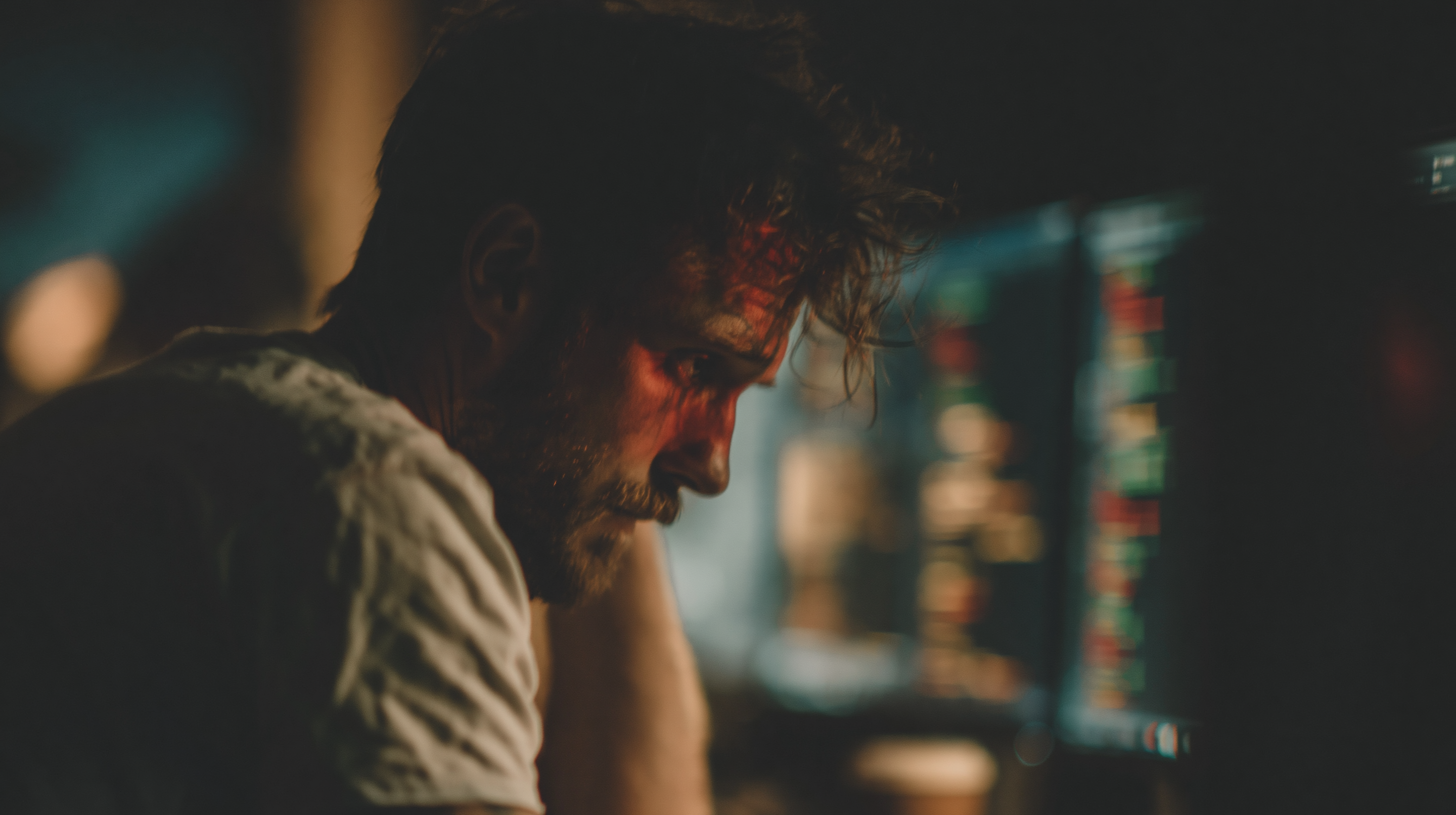 A lone software engineer sitting at a desk in a dark office at 2am.