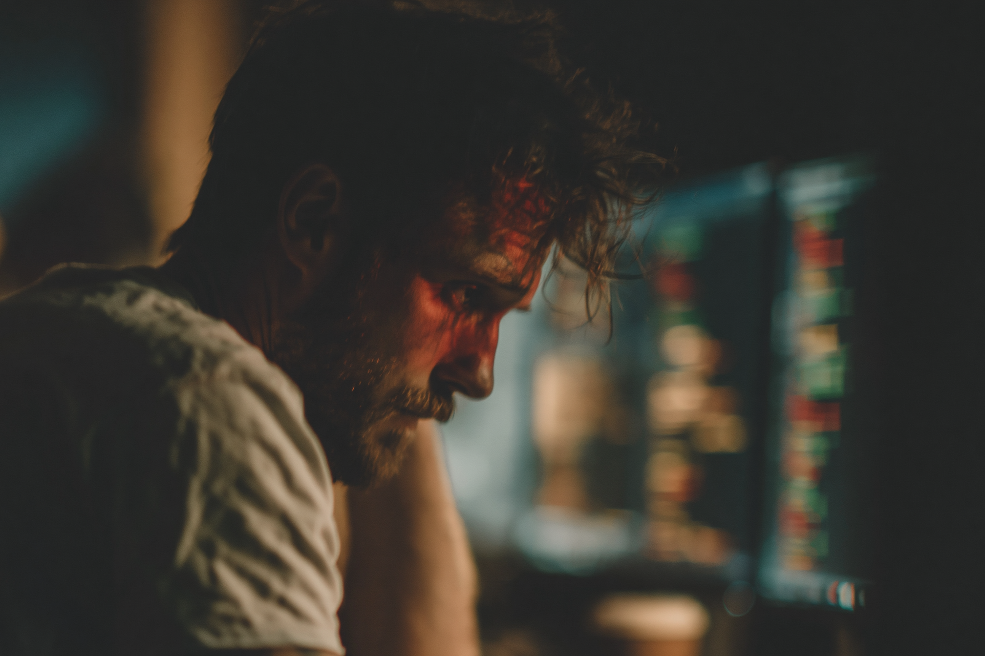 A lone software engineer sitting at a desk in a dark office at 2am.