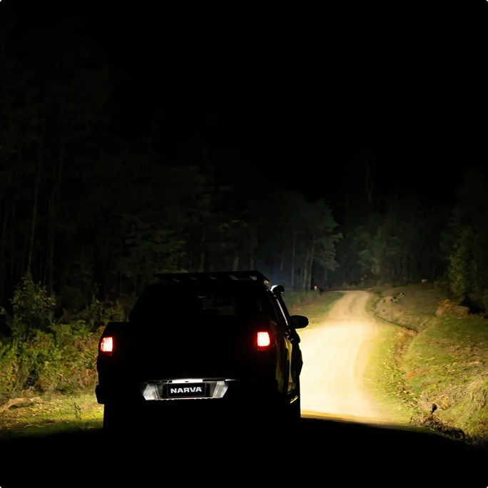 car on dark road at night
