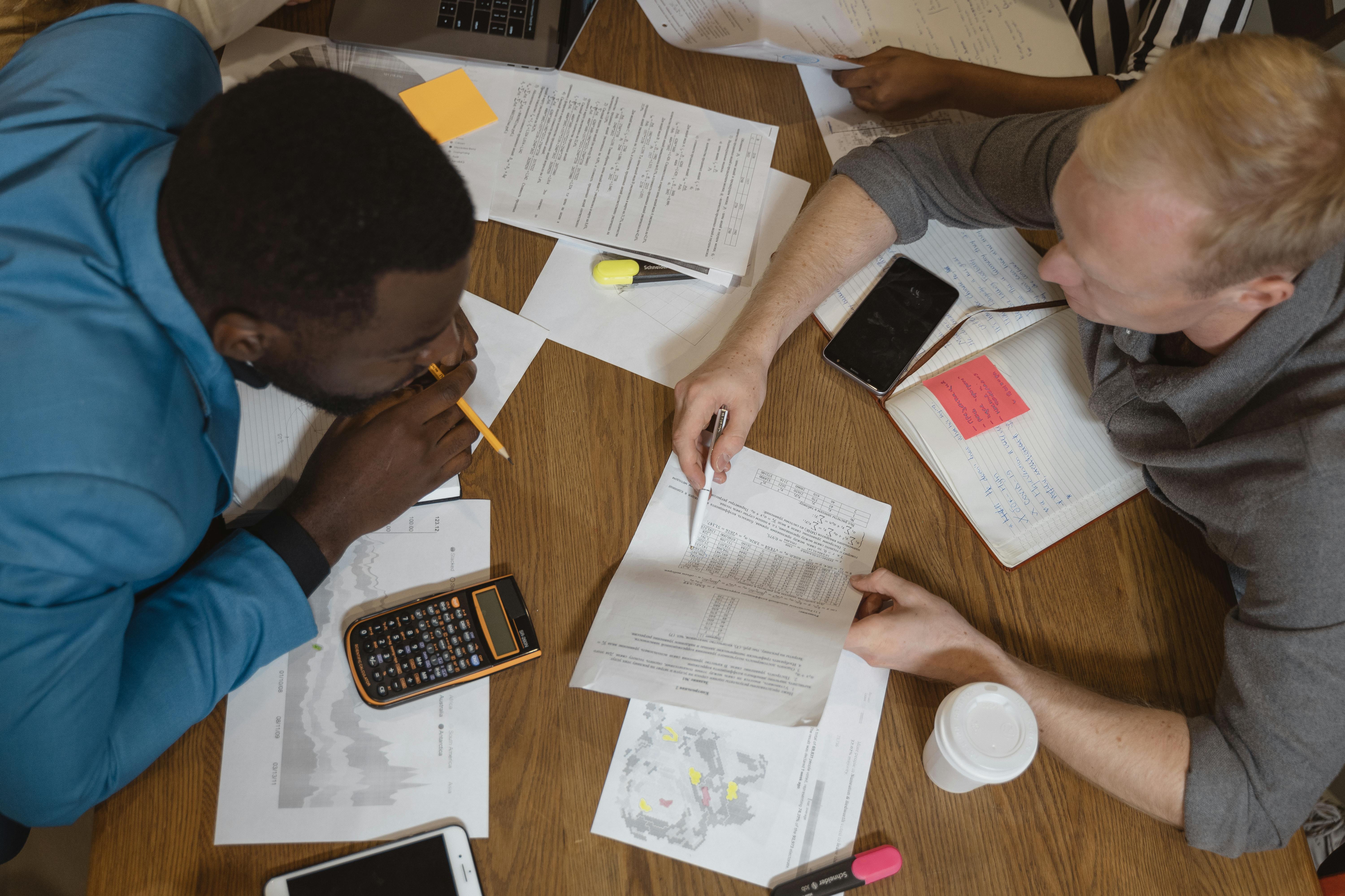 Two people around a table discussing finances.