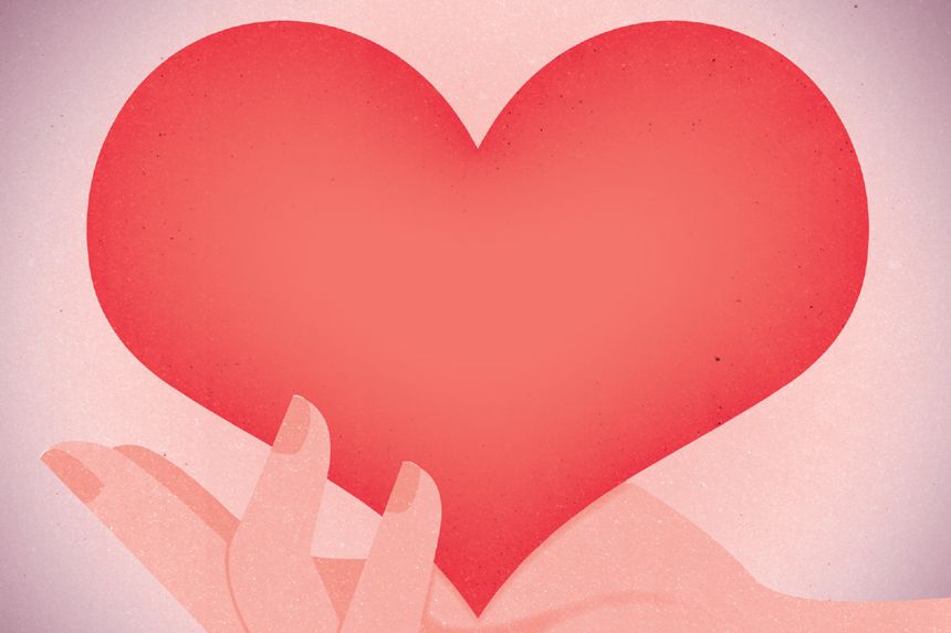 Tecknat rött hjärta i en hand