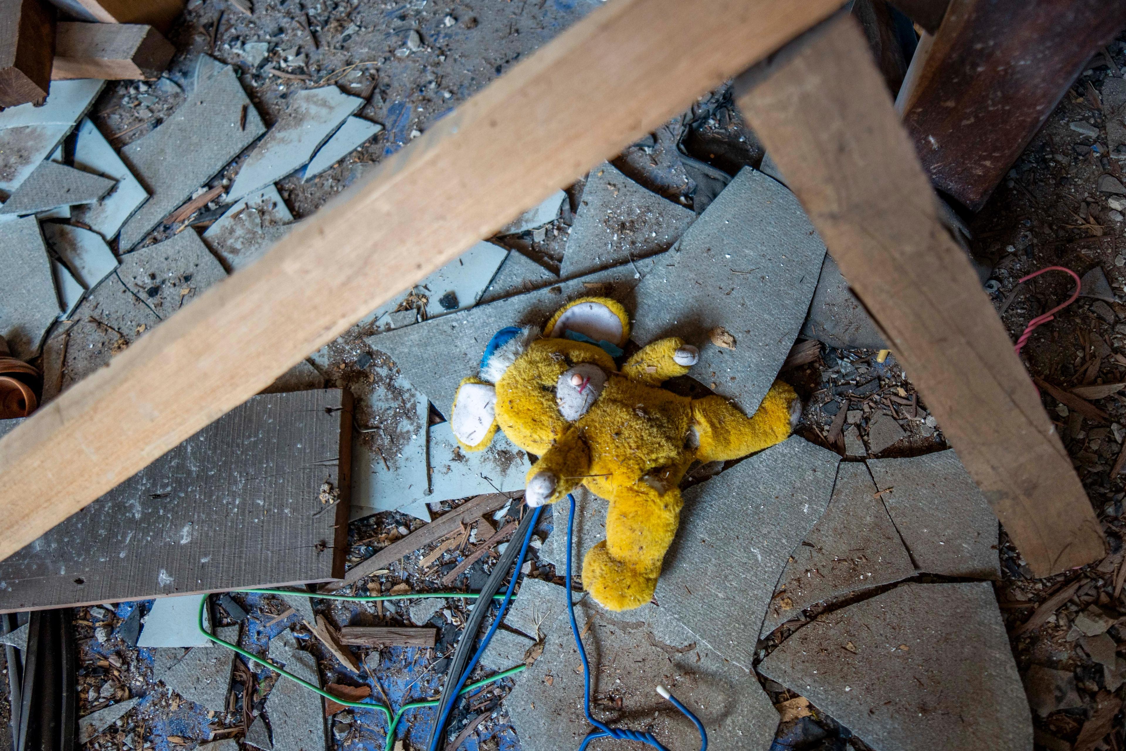 A child’s teddy bear remains in the ruins of a home in Sa Kaeo after it was hit by a Cambodian BM-21 rocket during border fighting.