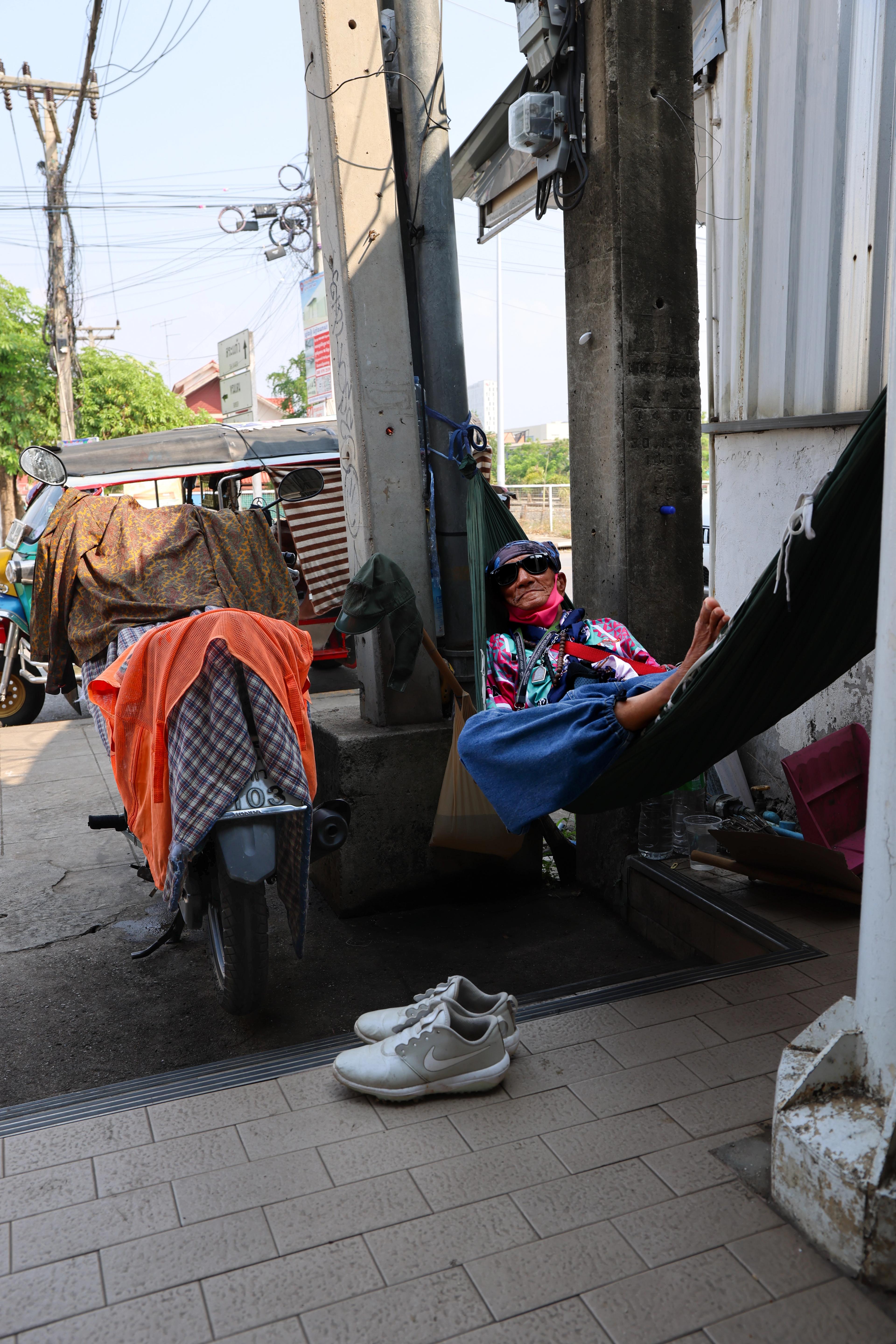 Wai Pakkard rests outside a 7-Eleven near the O Bey Jorn border checkpoint on the Thai side of the Thai-Cambodia border. 