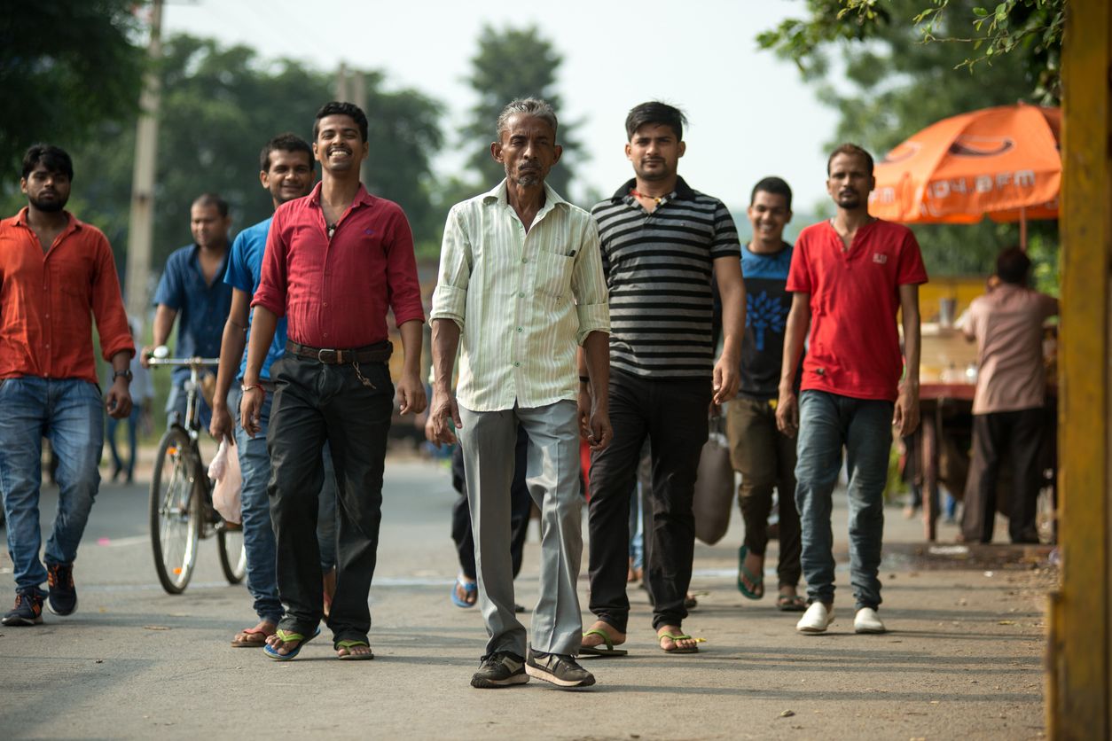 Unemployment among youth has emerged as the most teething issue in India. Here, a group of workers walking along the road.