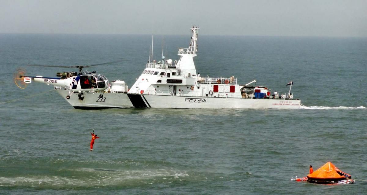 An Indian Coast Guard Chetak helicopter winches a survivor from the water during a search-and-rescue drill.