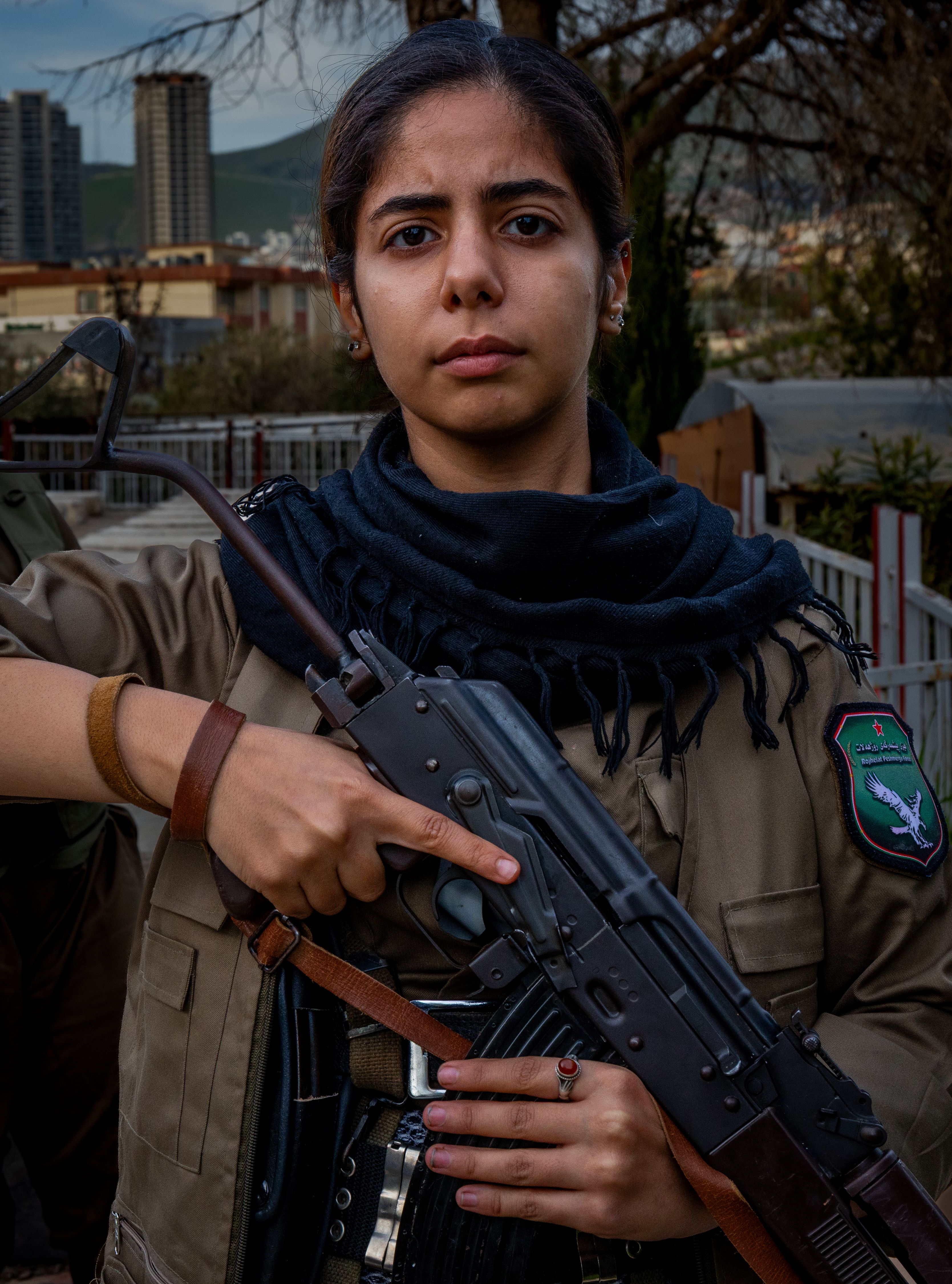 A Komala fighter mourns while standing at attention alongside fellow Iranian opposition guerrillas at the funeral of Ghazal Molan.