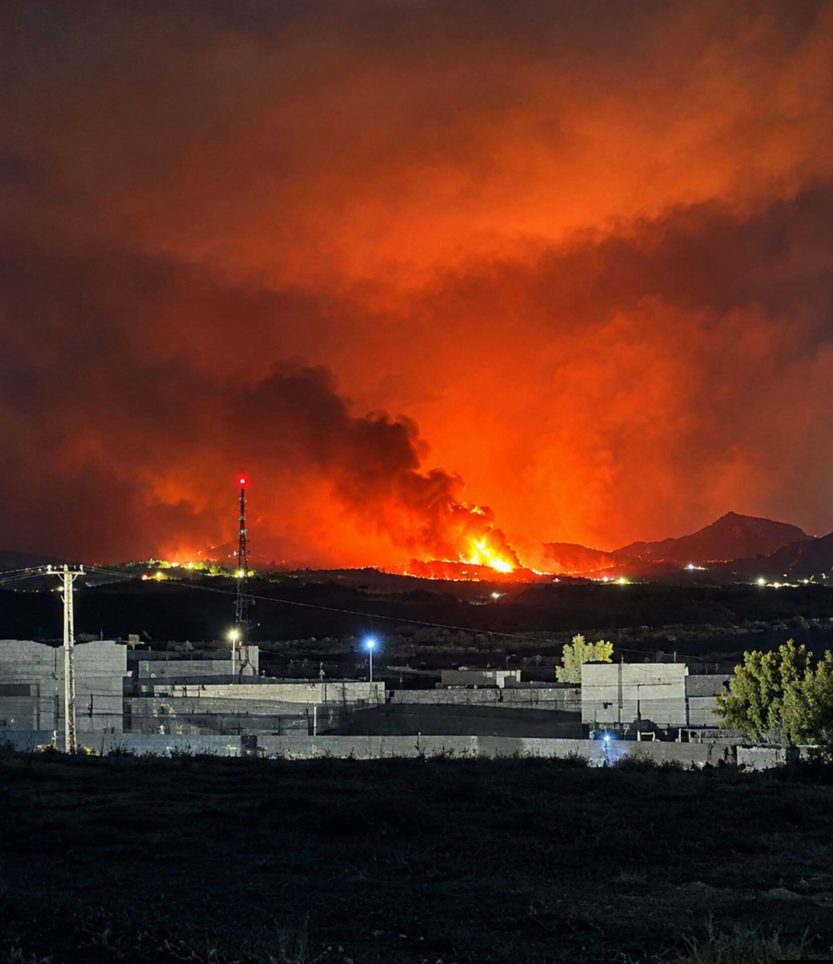 Fireballs and smoke rise from a site targeted by Pakistani airstrikes in Kandahar, the base of the Taliban's supreme leader, in the early hours of September 24.