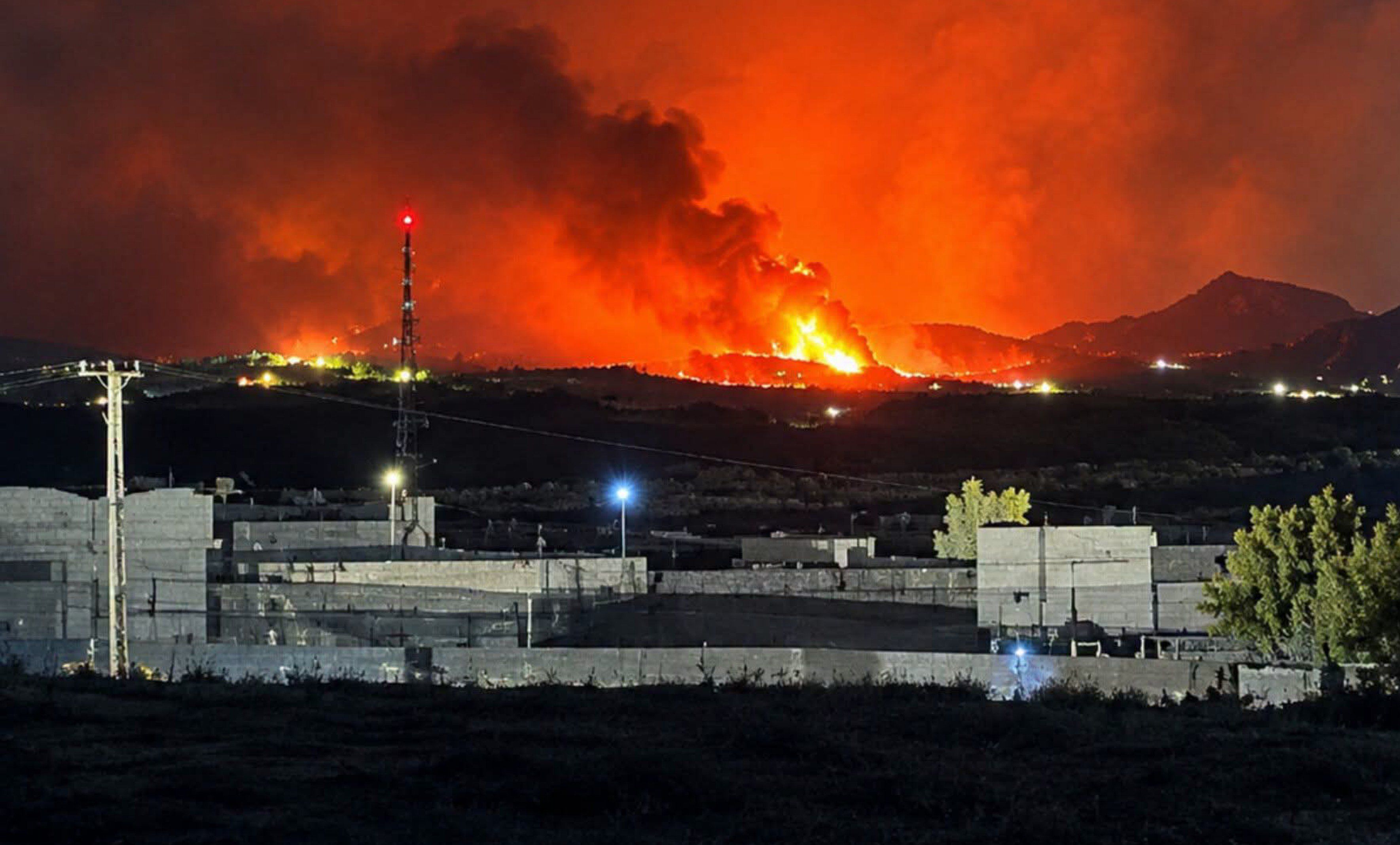 Fireballs and smoke rise from a site targeted by Pakistani airstrikes in Kandahar, the base of the Taliban's supreme leader, in the early hours of September 24.