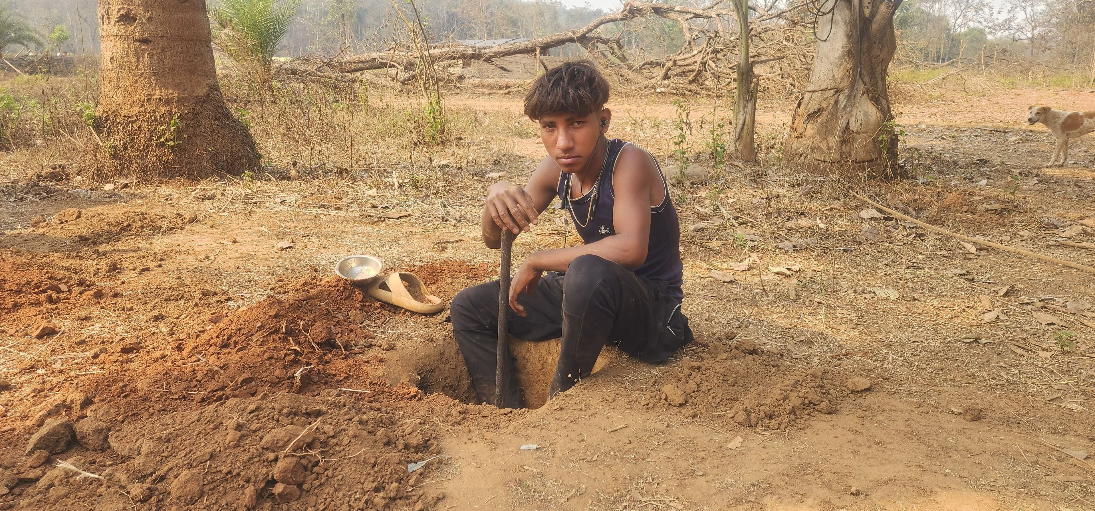 Sundarlal Wadde, 14, preparing ground for his grocery store in Baleveda village, Abhujhmad Hills, Chhattisgarh.