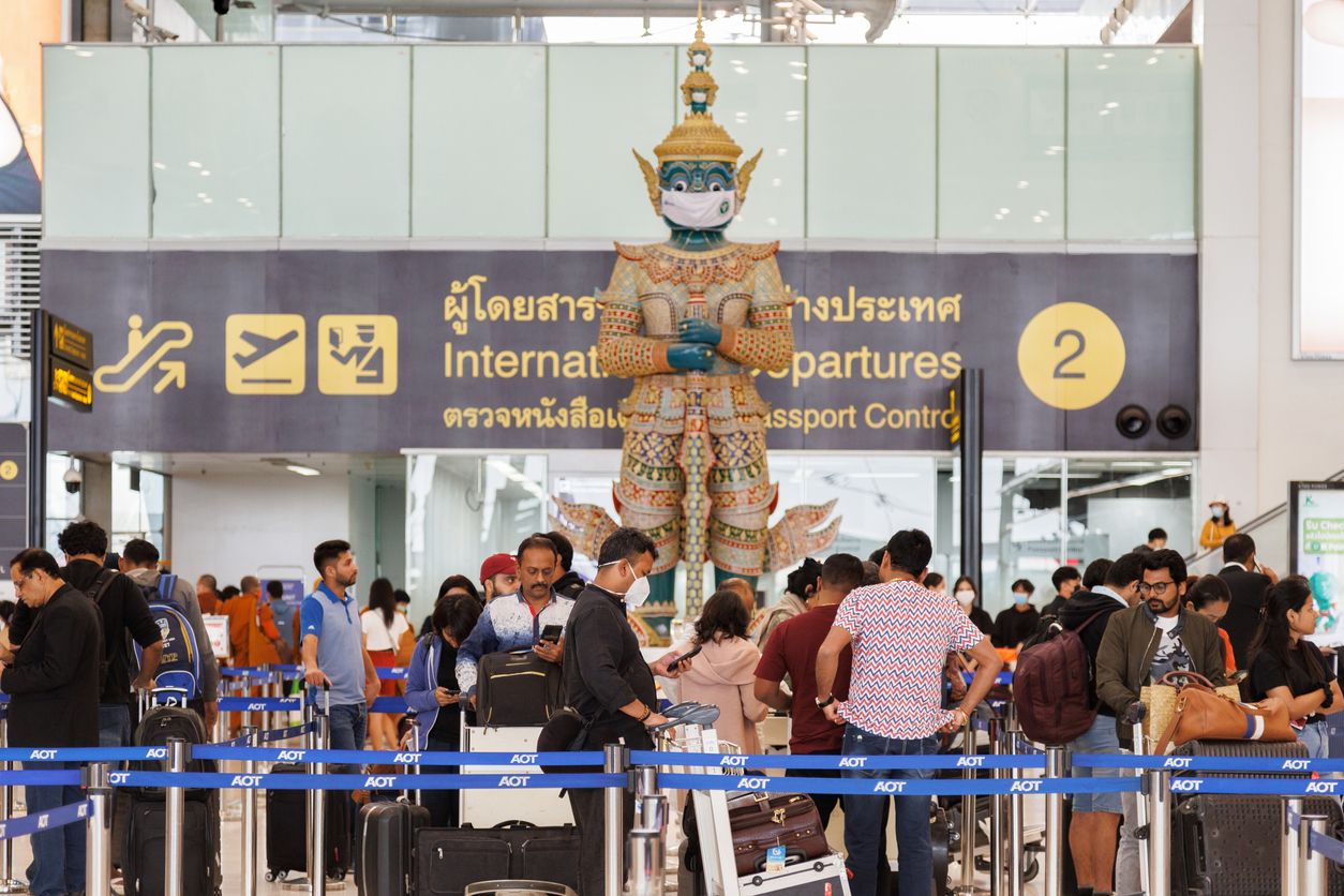 Travellers queue at an immigration checkpoint at Bangkok's Suvarnabhumi Airport.