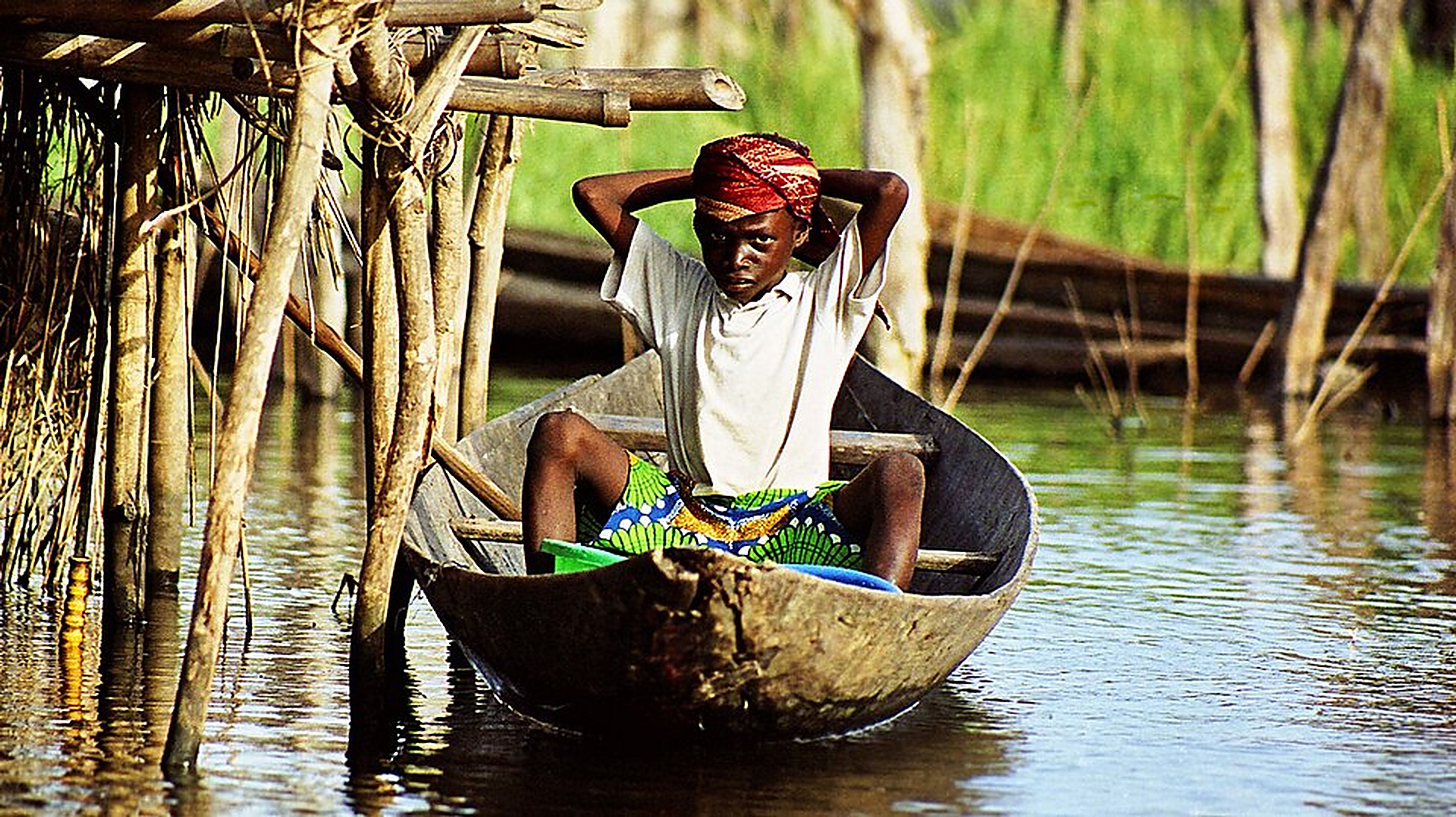 A boy sits in a canoe in Benin, Africa. The UN says an energy shock, a severe El Niño and 9 per cent borrowing costs could push hundreds of millions of people back into poverty. Photo: Dr Ondřej Havelka
