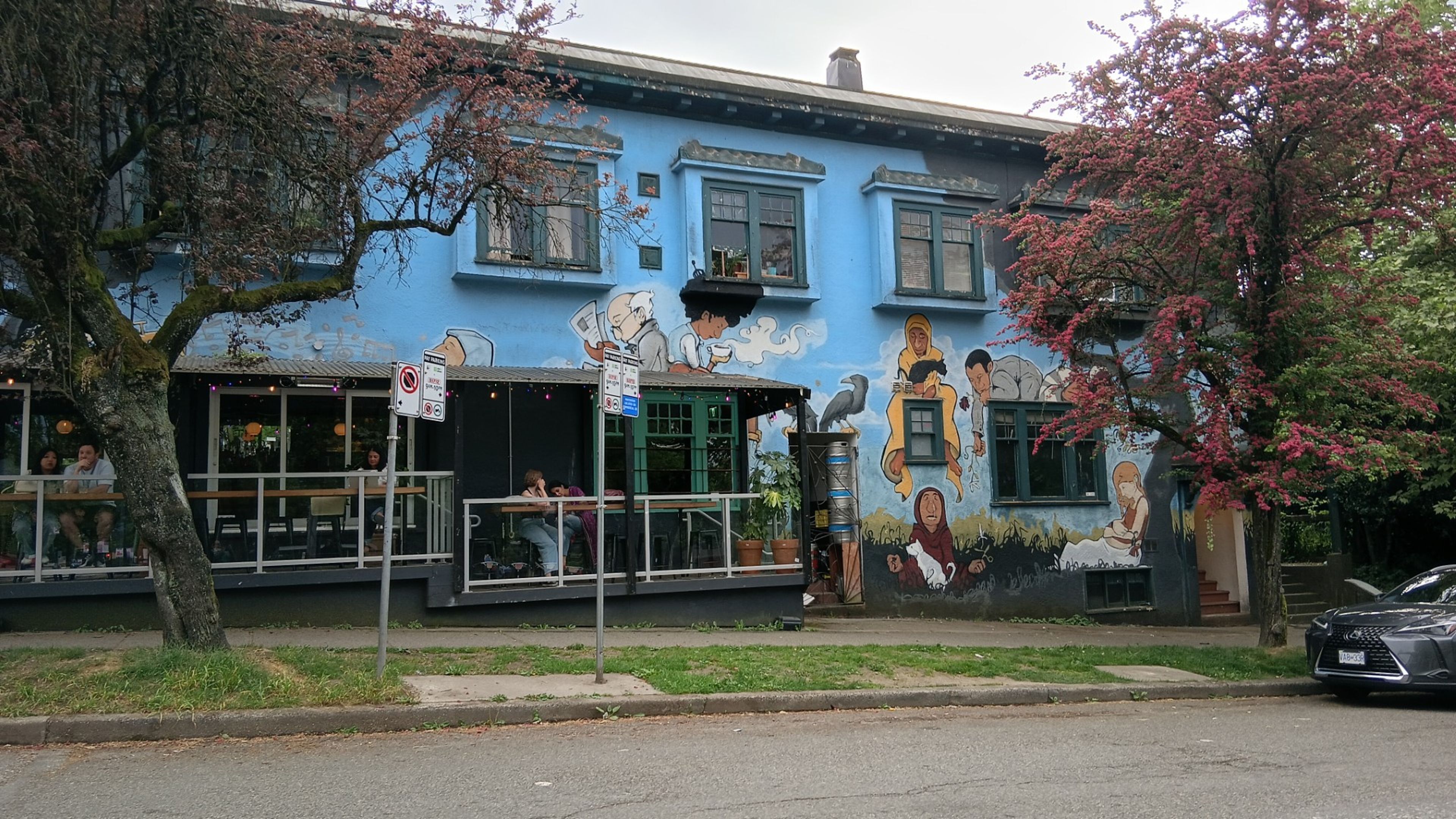 A cafe and mural on Commercial Drive capture East Van’s blend of community art and street-level activism. Photo: Ajay Kamalakaran