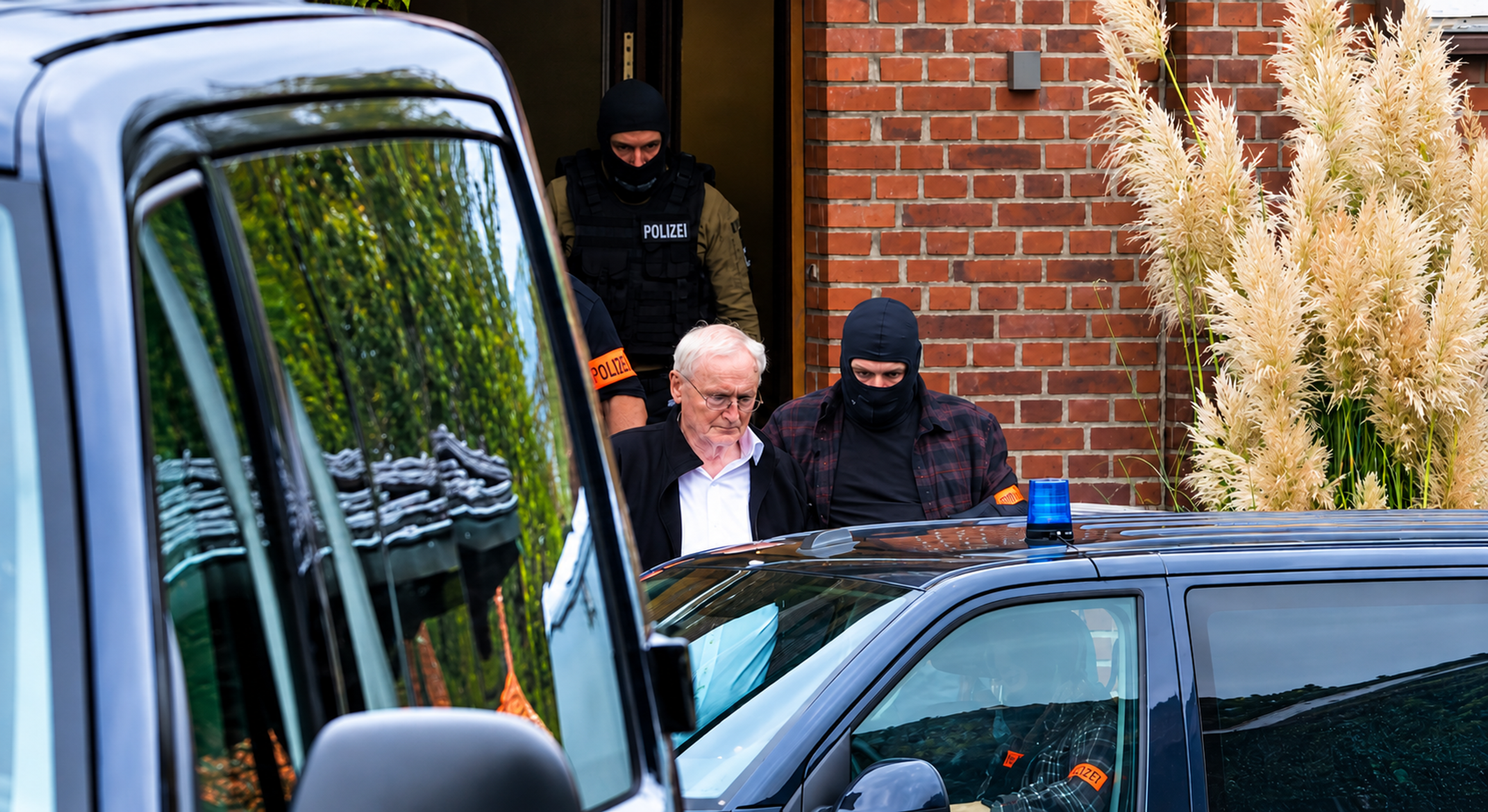 Former BND chief August Hanning is escorted by police from his home in Nordwalde, Germany, following his arrest on suspicion of espionage and attempted treason on October 6, 2026. Photo: WDR/Westdeutscher Rundfunk