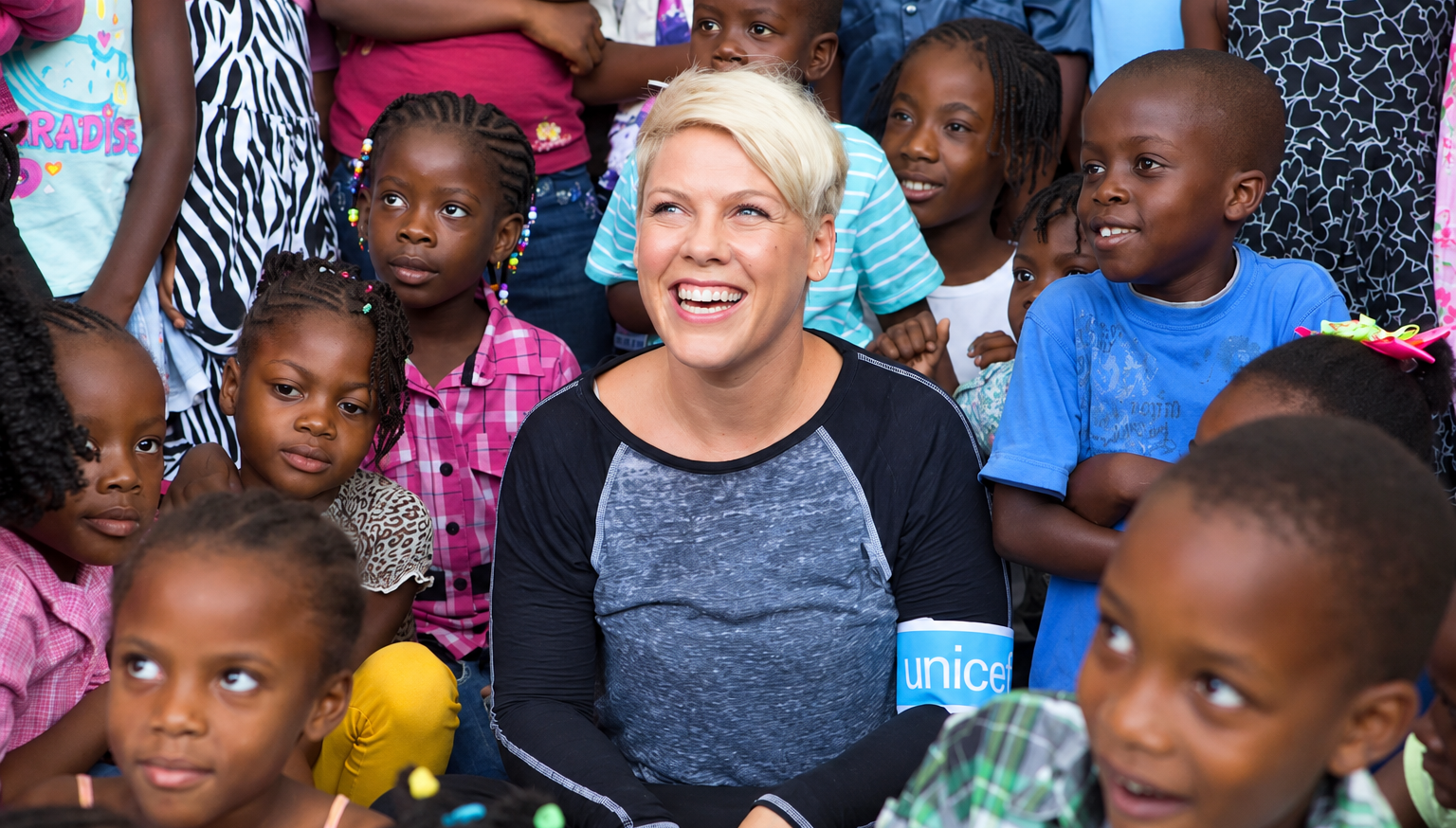 Pink, UNICEF Goodwill Ambassador, with schoolchildren at a UNICEF-supported school in Haiti during her 2015 visit. Photo: Michael Crook for UNICEF