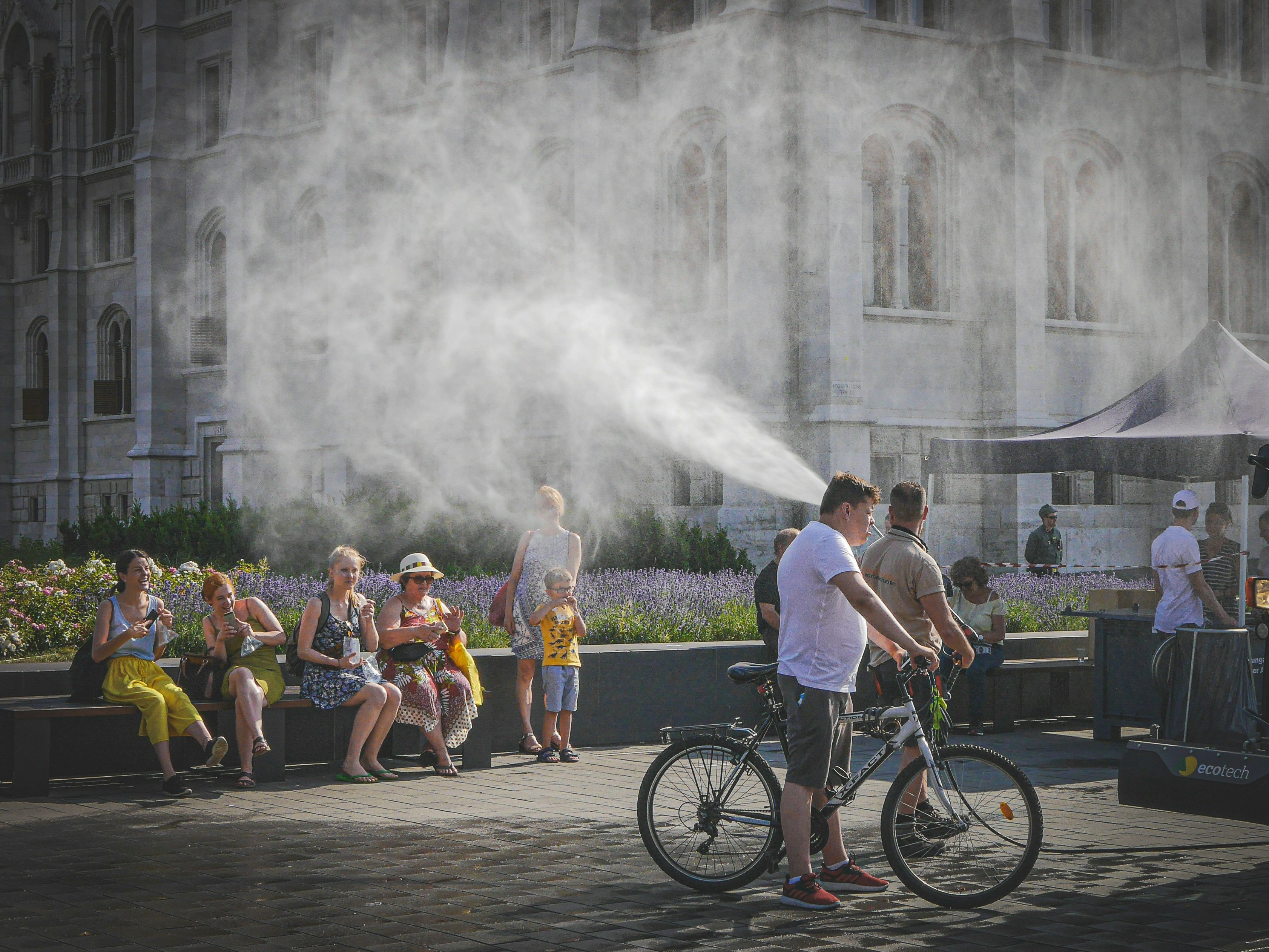 People cooling off from mist spray on a hot day in Budapest