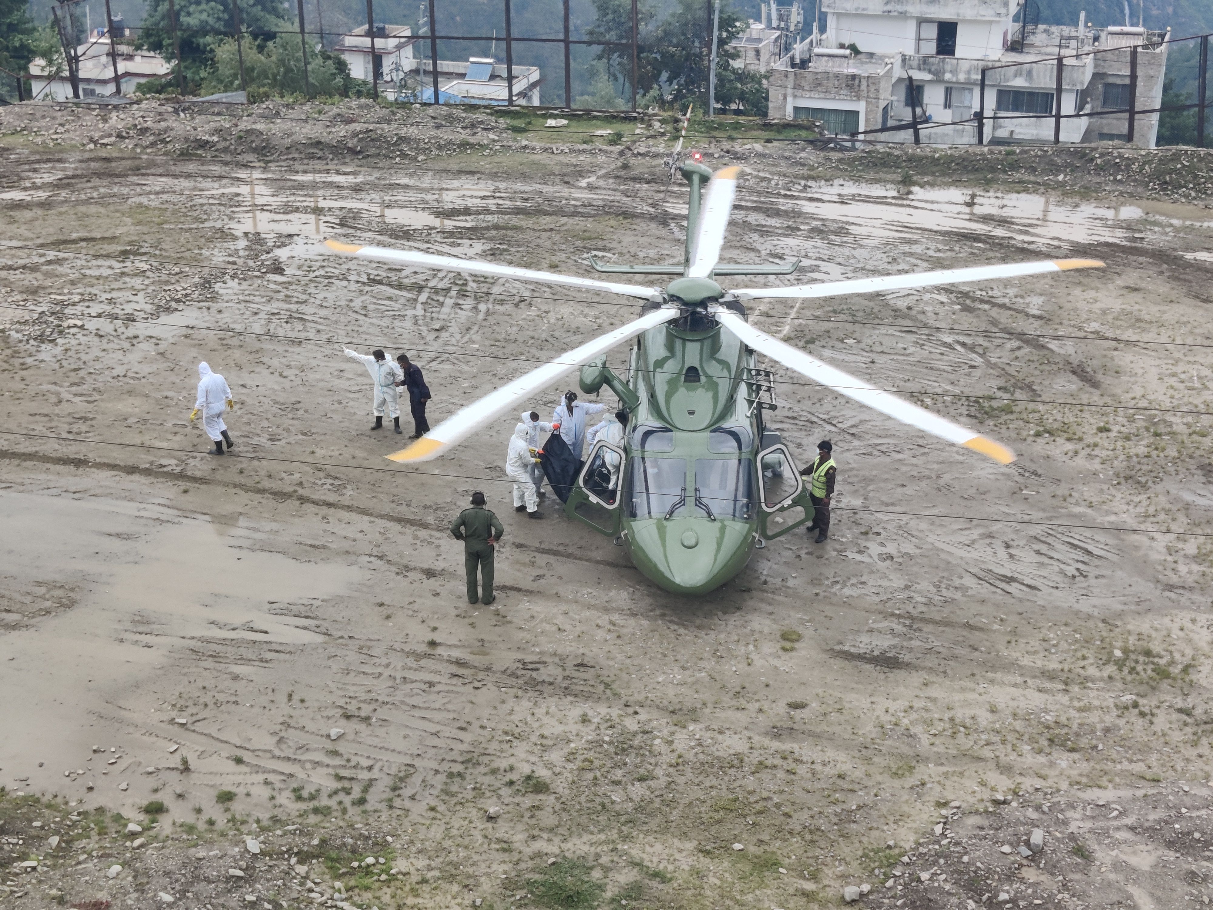 Relief personnel gather around a helicopter on September 4, 2026 during flood-relief operations in Betrawati town along the Trishuli River in Rasuwa district, Nepal. The area was affected by severe flooding and debris. Photo: Yogesh Nepal