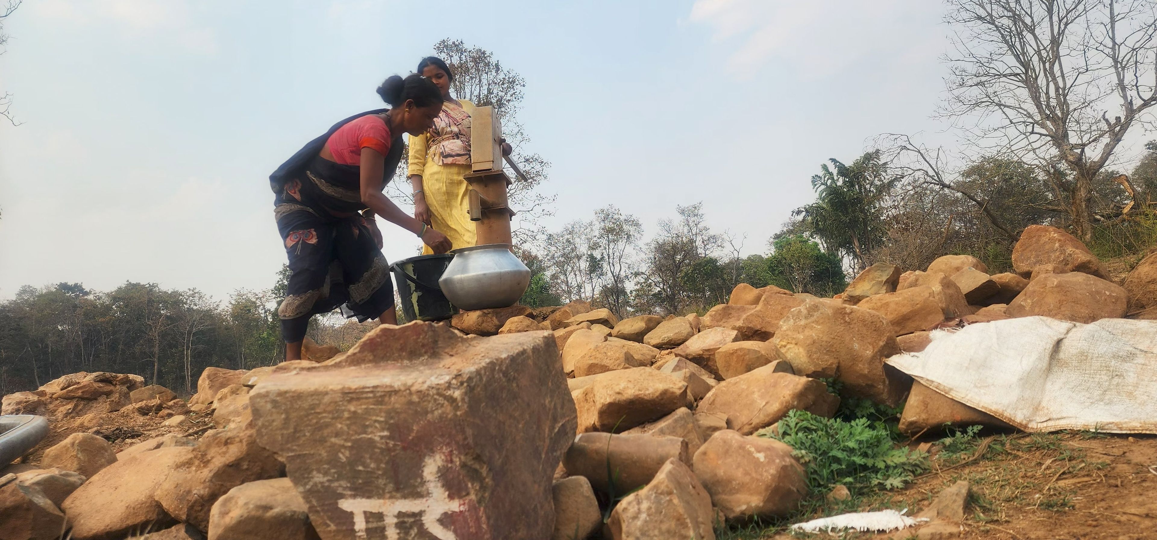 Women draw water from a newly installed handpump in Baleveda village, Abujhmad Hills. The government says it is trying to develop basic infrastructure in the tribal villages.