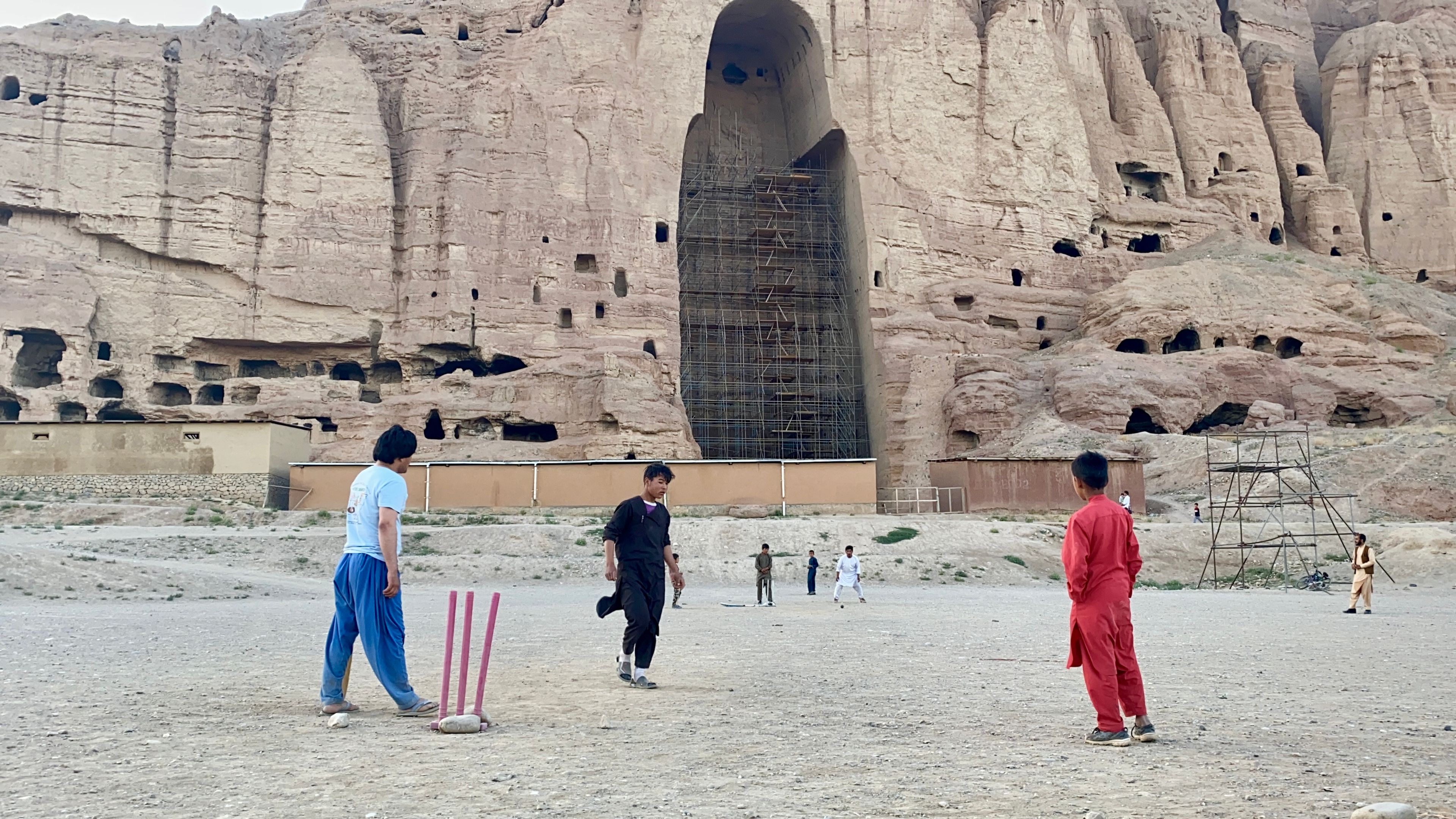 Children play in front of the Buddhas of Bamiyan site in Bamiyan City, Afghanistan, where the monumental statues were destroyed in 2001.