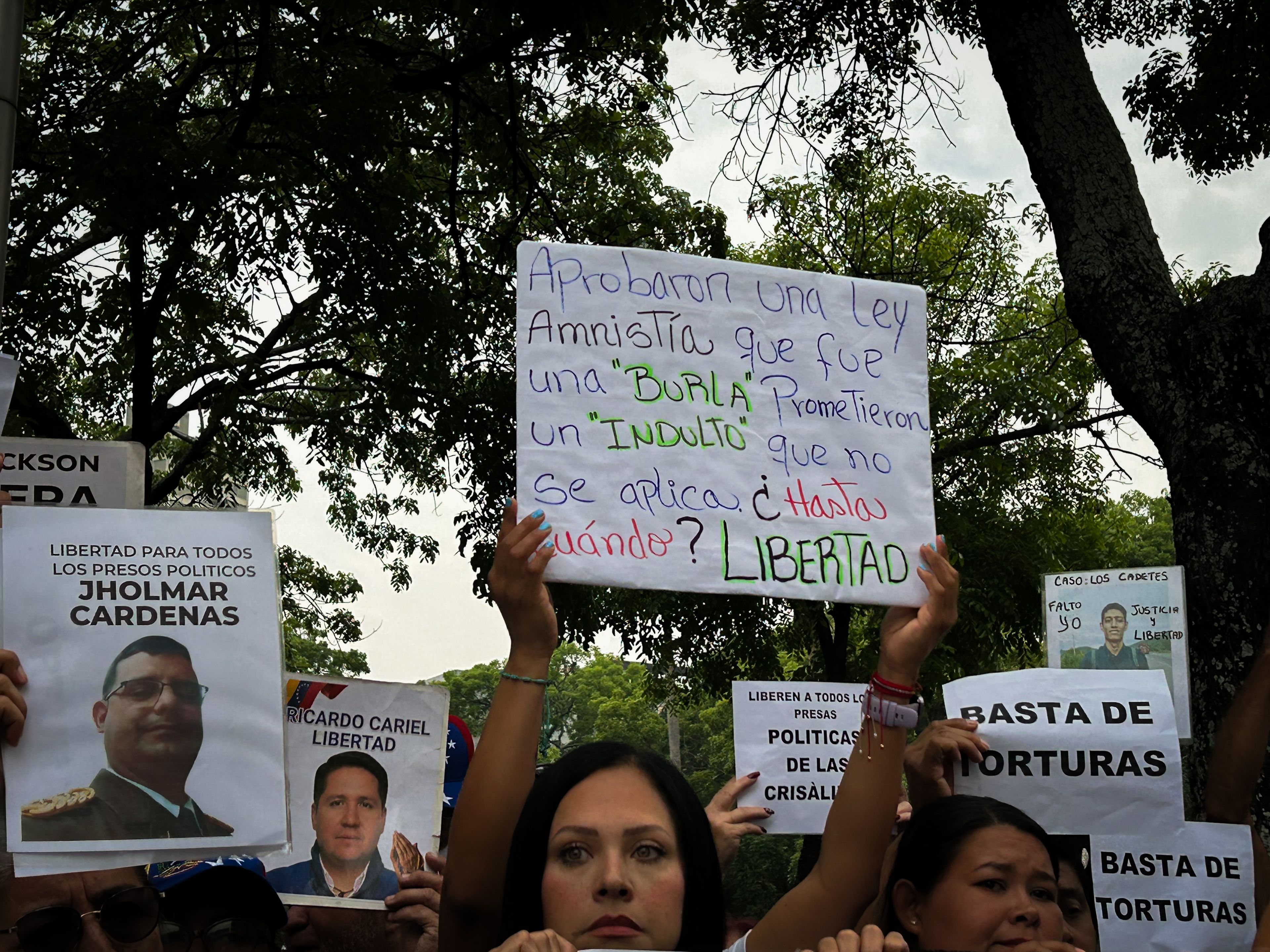 Venezuelans hold placards calling for the release of political prisoners during a demonstration in Caracas. Photo: María José Dugarte