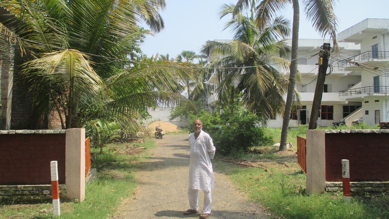 Subba Rao, founder of Ideal School in Jinnuru, Andhra Pradesh standing inside the sprawling campus.