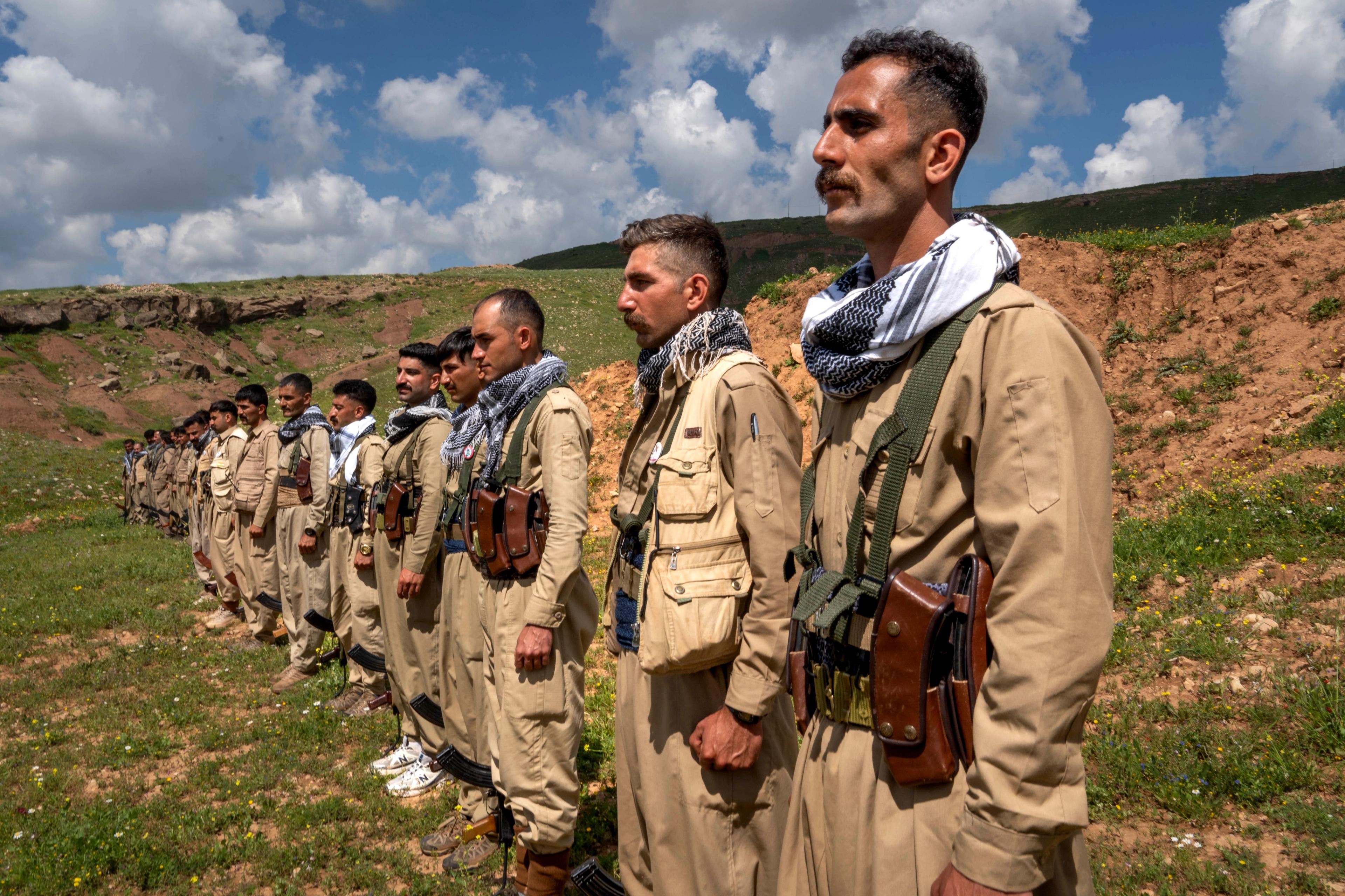 Iranian opposition militants stand at attention during a military inspection by KDPI General Kawa Bahrami. 