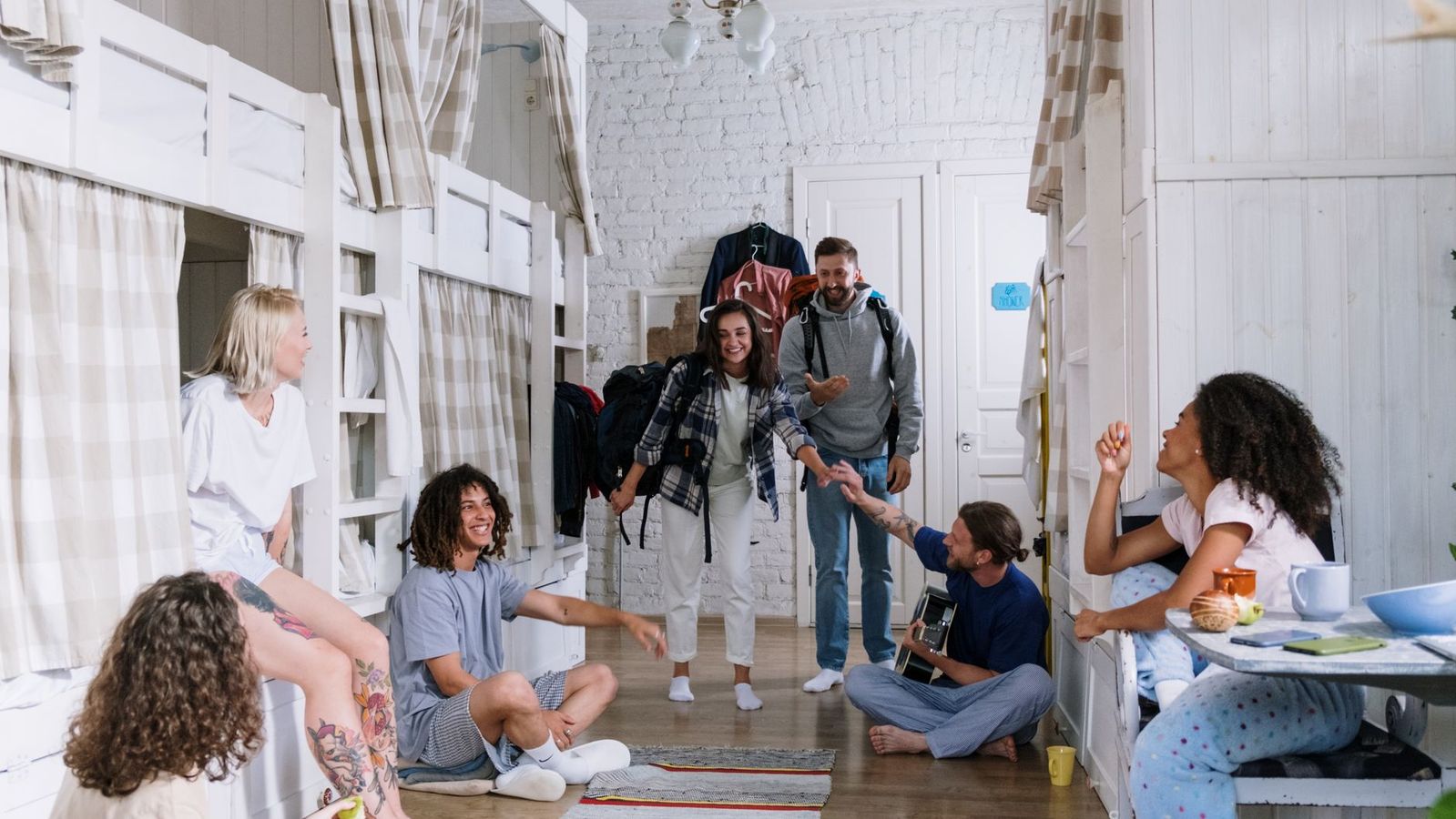 College friends relaxing together in a furnished room near campus