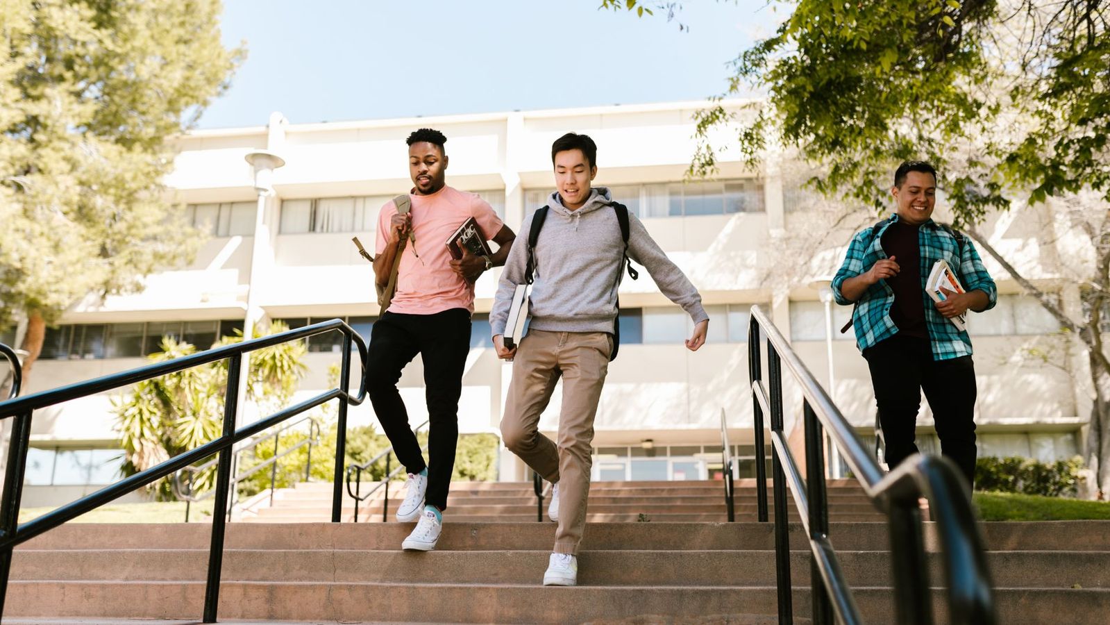 College students staying active while walking down outdoor campus stairs