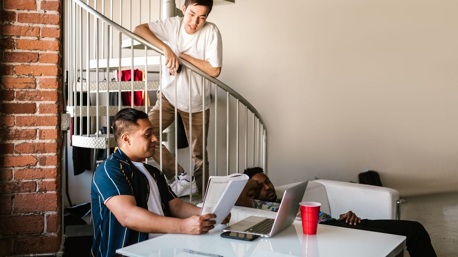 College roommates studying together in a shared apartment living space near campus