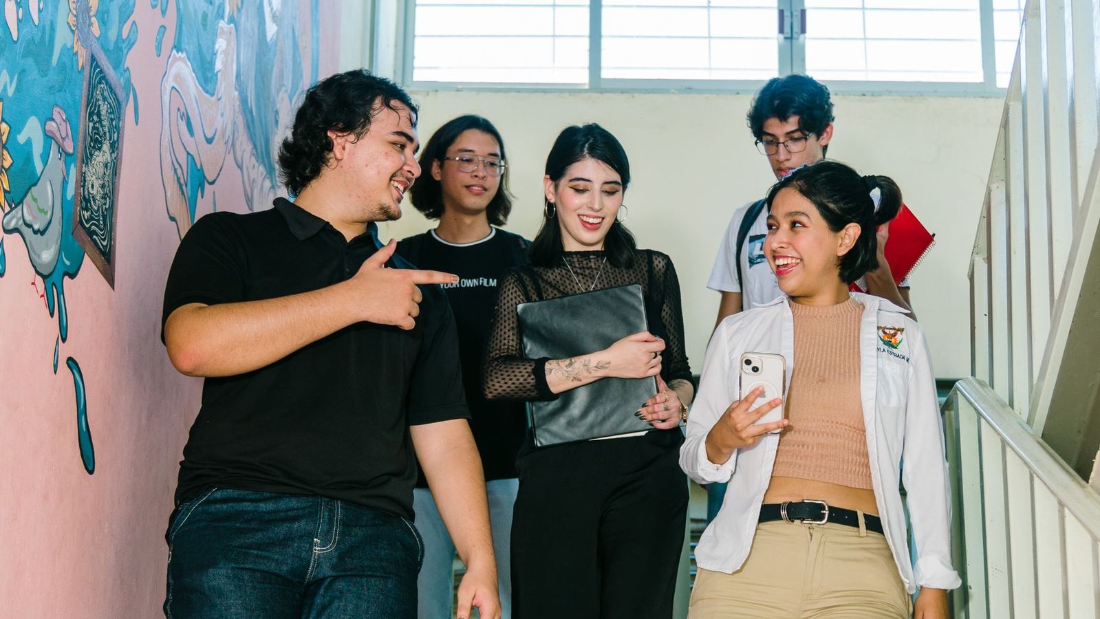 College student folding laundry in a bright apartment near Santa Monica campus housing