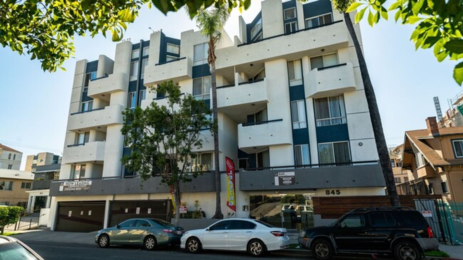 College roommates sharing a bright multi-bedroom apartment living room near a Los Angeles campus