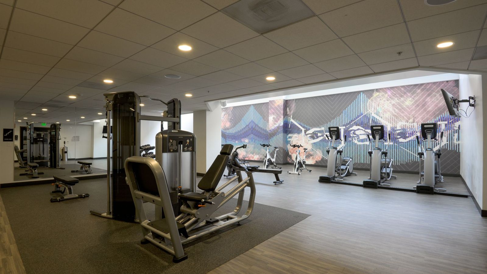 Modern fitness center with cardio and strength equipment for UCLA apartment residents