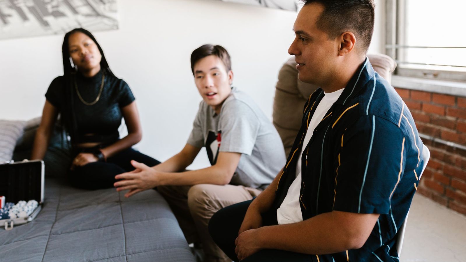 Students relaxing in a furnished room while comparing off-campus housing near UCLA