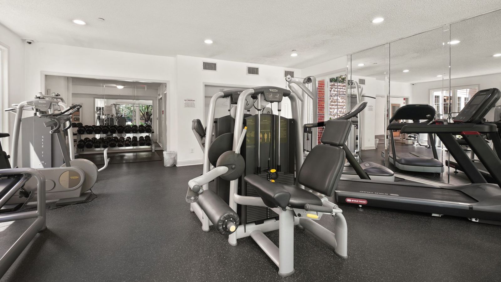 Empty apartment fitness center with weights and treadmills for USC student housing