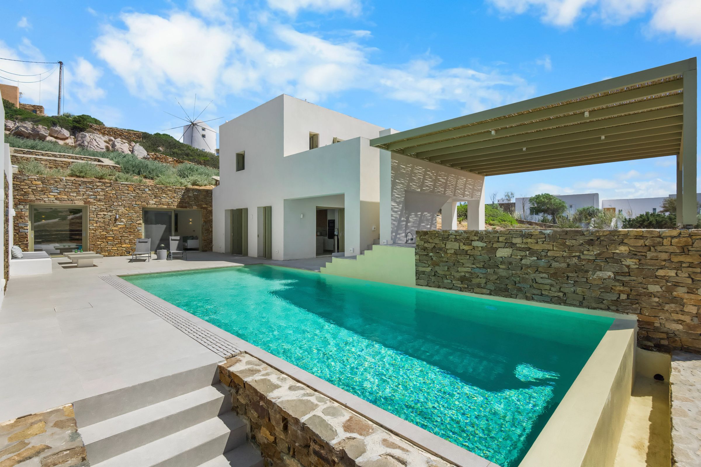 The exterior of the house showing a big pool