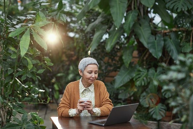 woman with laptop in a garden