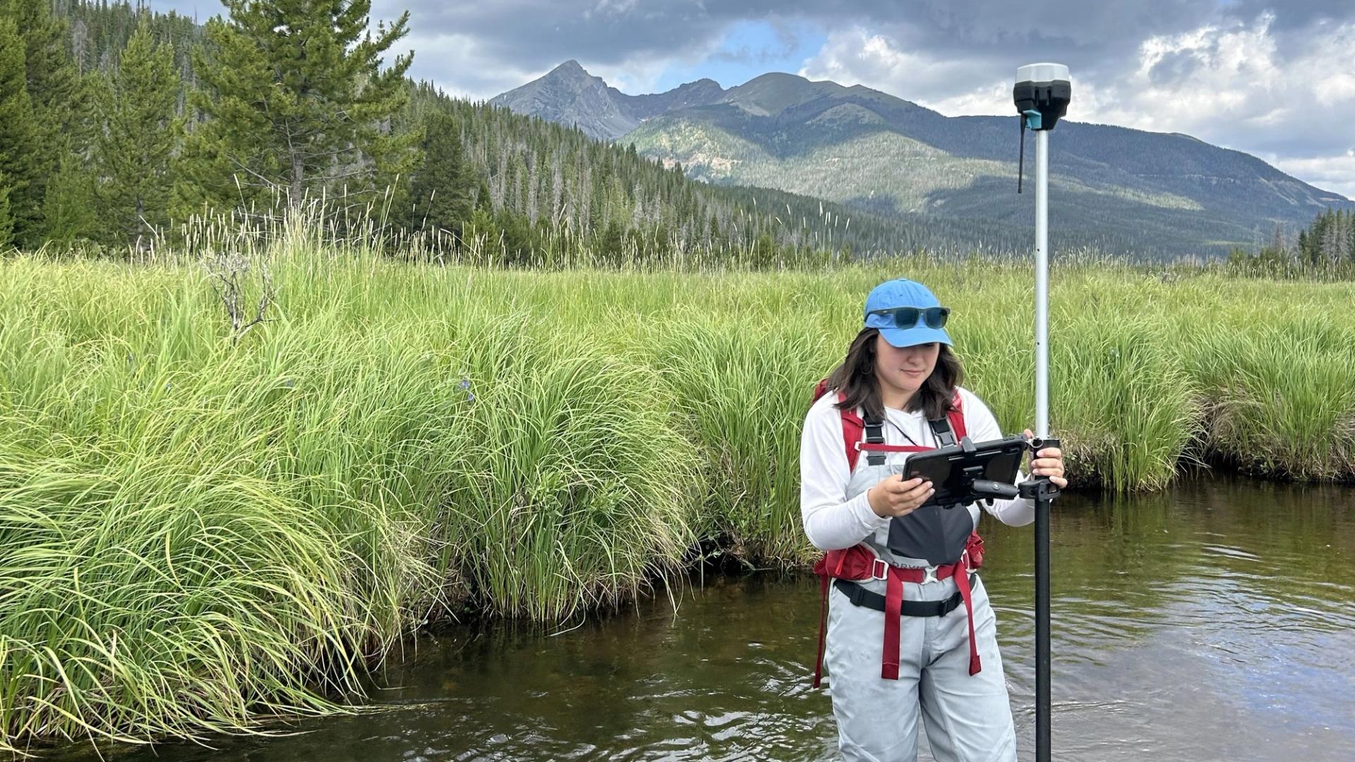 Graduate Student Research Grant Recipient taking stream measurements in the field