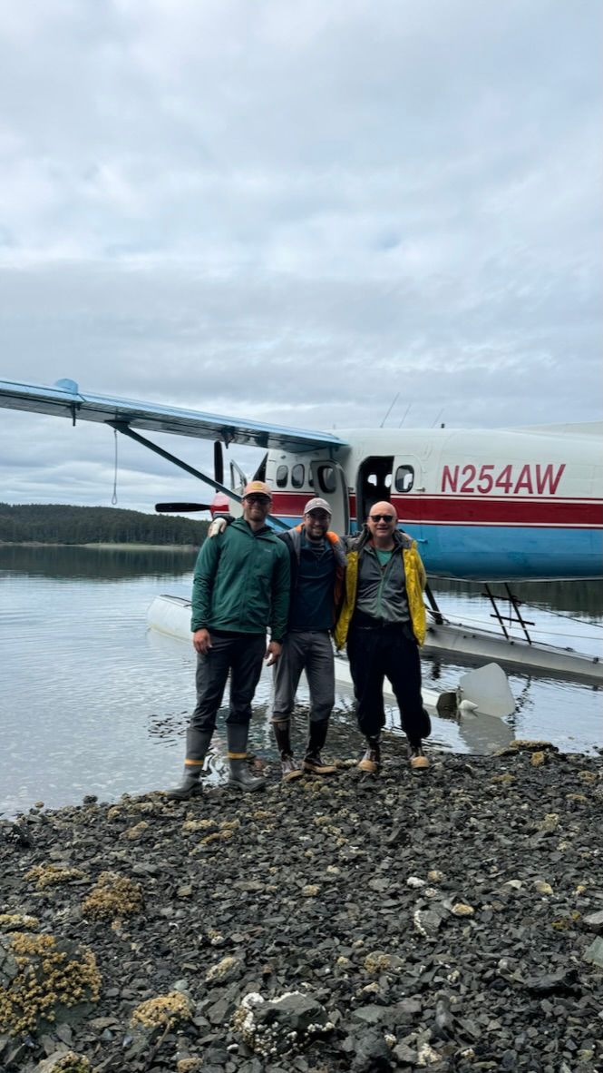 Researcher Brandon Keough and his team during a field expedition in a remote coastal or lake region.