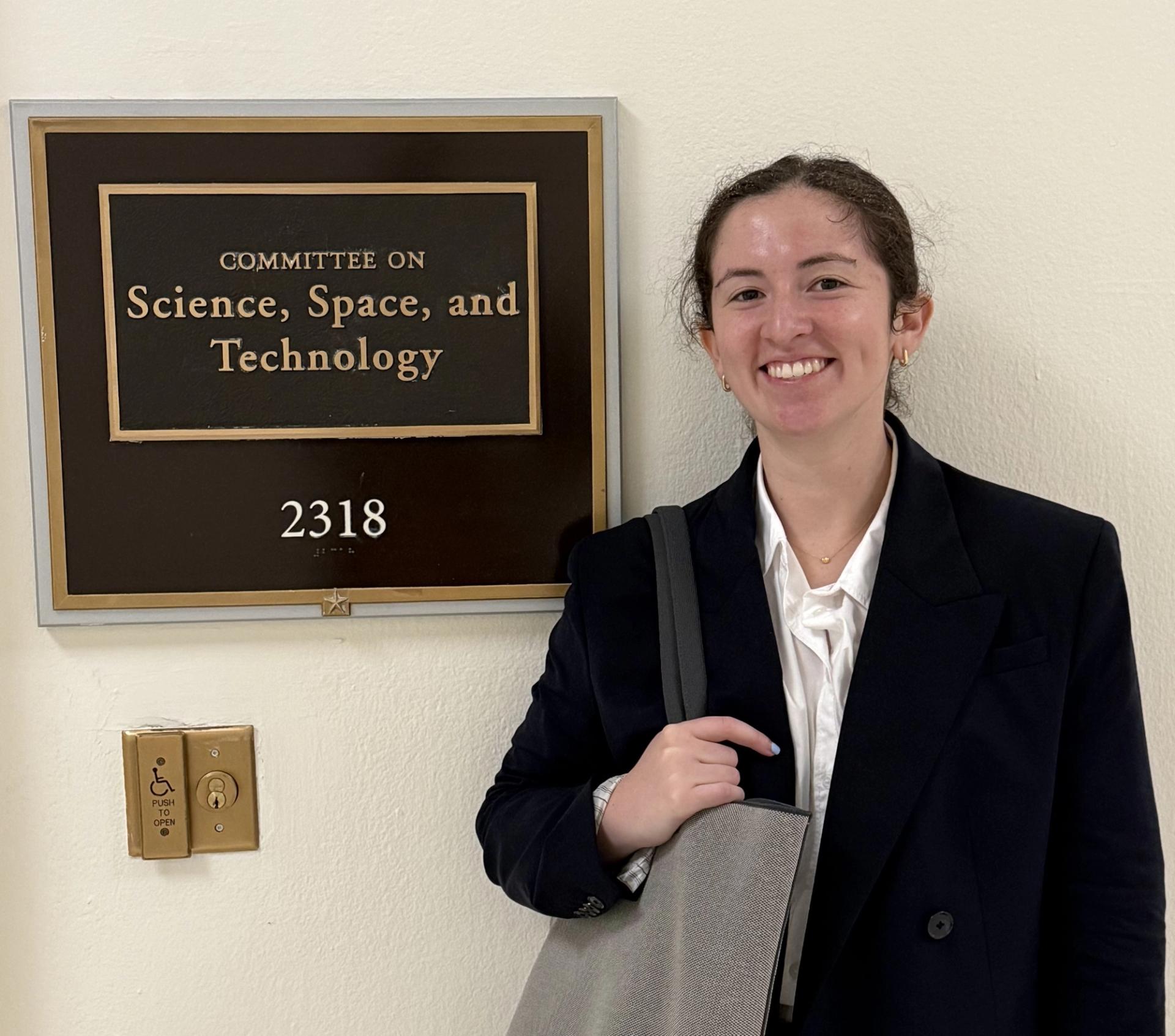 GSA geoscientist in Capitol in front of science, space, and technology committee sign on Geoscience Congressional Visits Day.