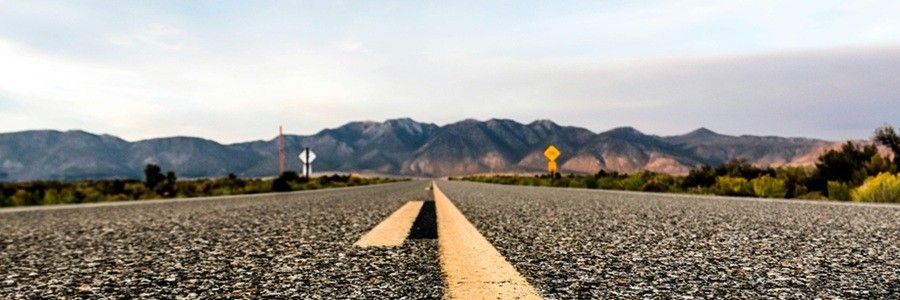 Photo of a road, with a mountain landscape in the background