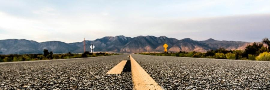 Photo of a road, with a mountain landscape in the background